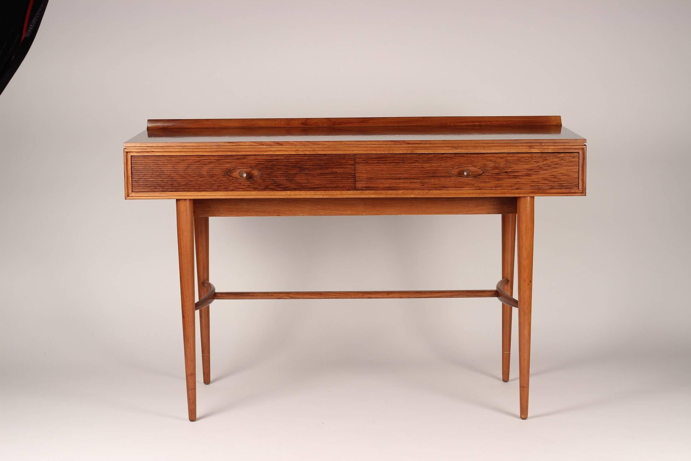 A versatile desk from the English maker and wonderfully sounding Archie Shine. Robert Heritage worked on a number of pieces including the Hamilton range which included sideboards and tables. This desk functions equally well as a writing table or