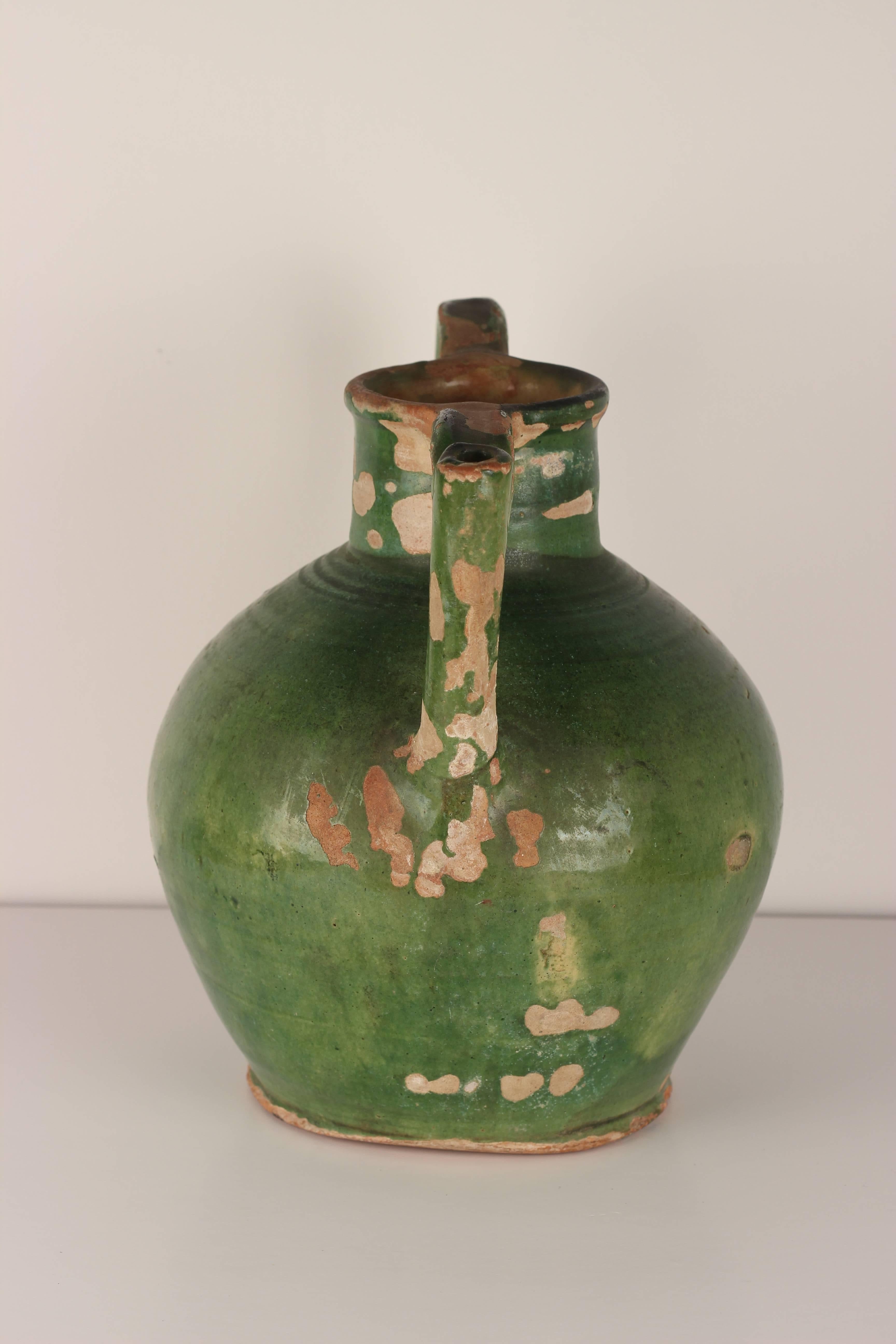 A very rare antique French glazed terracotta water spout handle jug in original condition .These jugs were used primarily in the South of France. Chips and imperfections help authenticate and give these jugs great character.