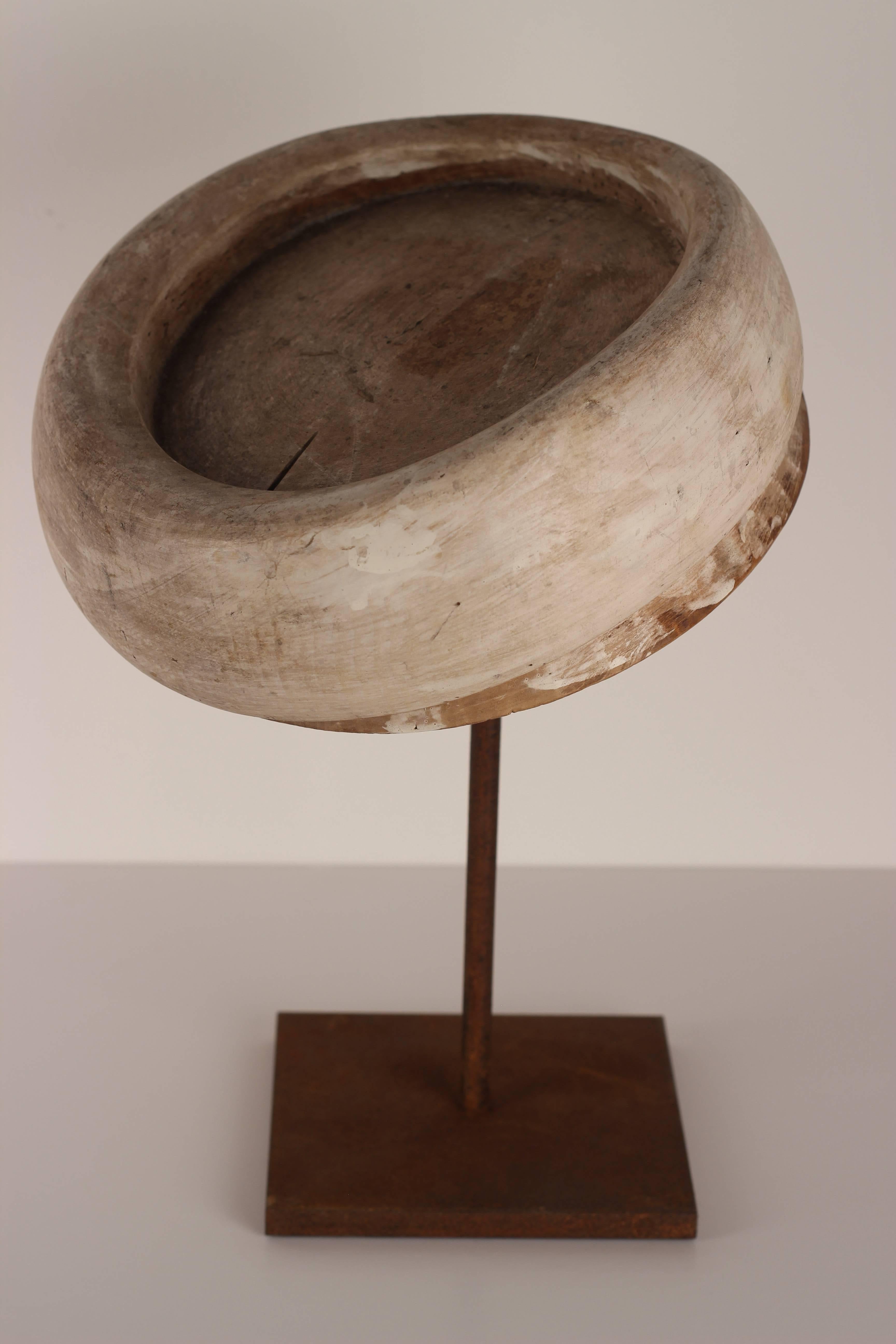 One of a collection of hat blocks from the well-known Milliners of Florence. This example is mounted on an oxidized display stand.