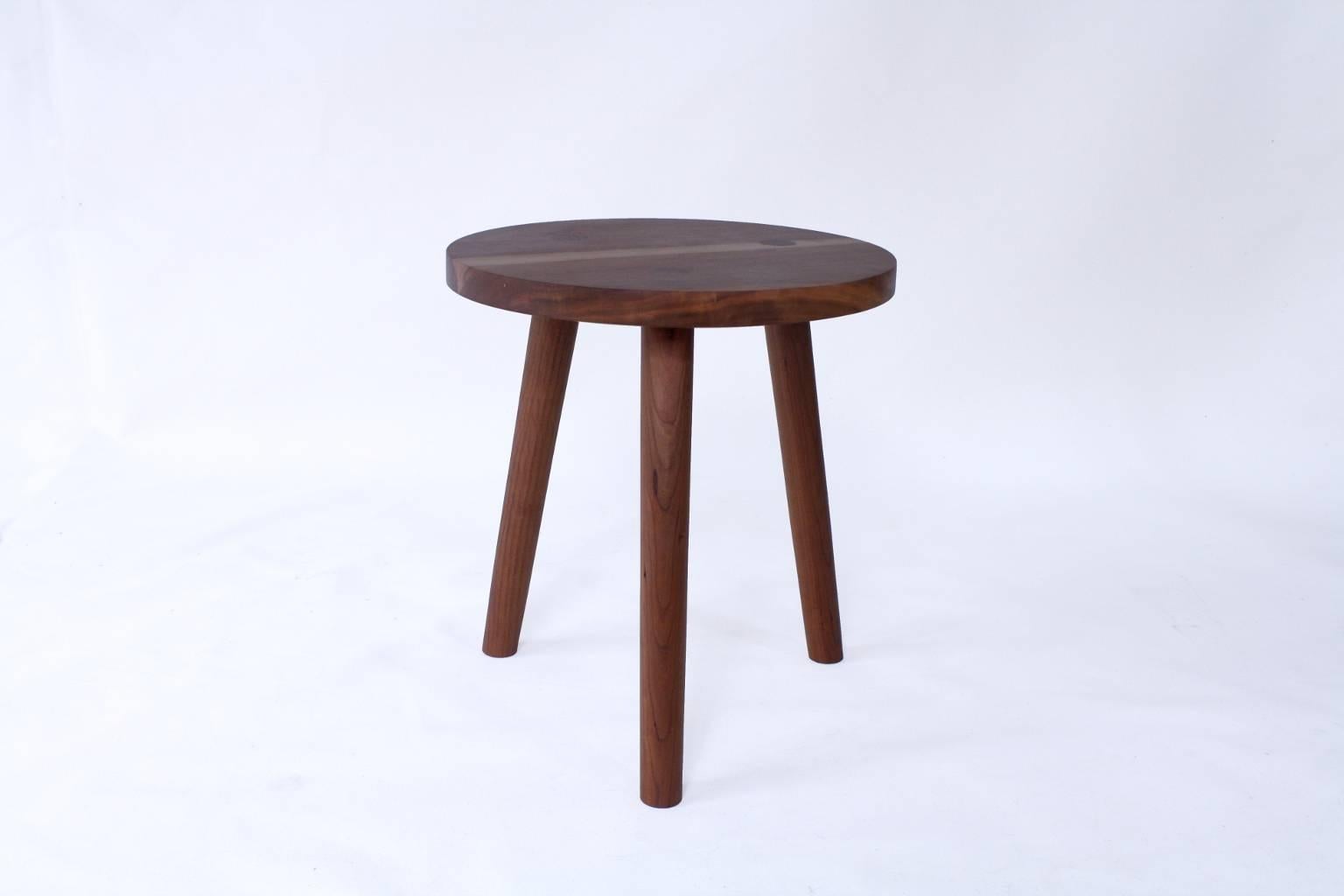 Handmade in Chicago by Laylo Studio, this solid hardwood stool or side table features hand-turned, tapered legs joined to the seat using through wedged tapered tenons, a construction technique found in traditional Windsor chairs. The hand-shaped,