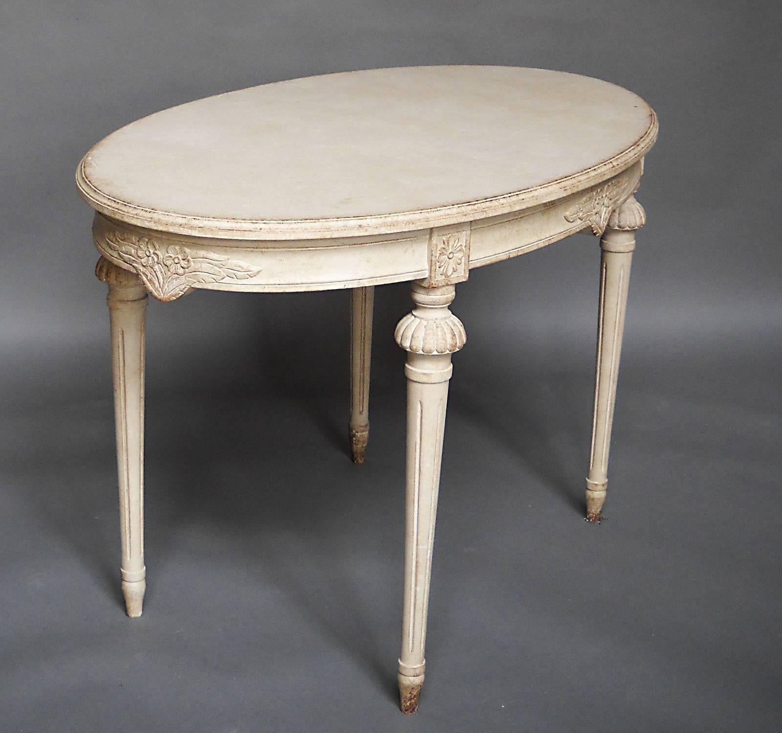 Lovely oval table, Sweden, circa 1910, in the Gustavian style. The apron is carved with bunches of spring flowers, with a rosette at the top of each leg. The legs themselves are round and tapering with carved elements at the tops.