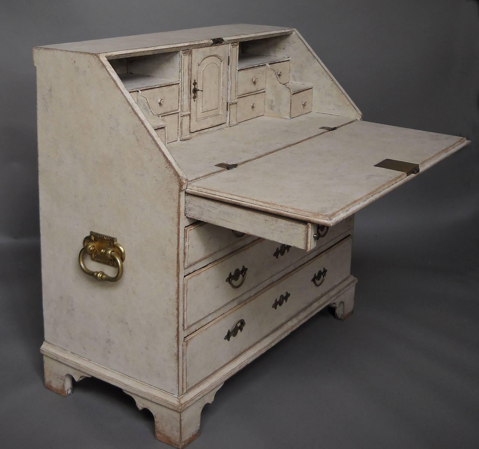 Swedish slant-front writing desk, circa 1780, with fitted interior and retaining its original brass hardware. Behind the drop front are several banks of stepped drawers, two disguised document drawers and a compartment with a signed drawer and