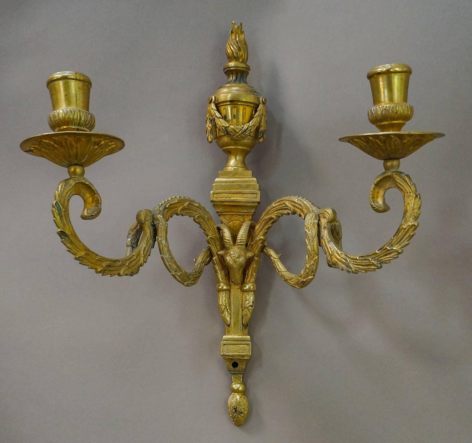 Pair of Gustavian bronze candle sconces, Sweden, circa 1760, with two lights in each. Wonderfully detailed casting with flaming urns, rams’ heads, and acanthus swags.