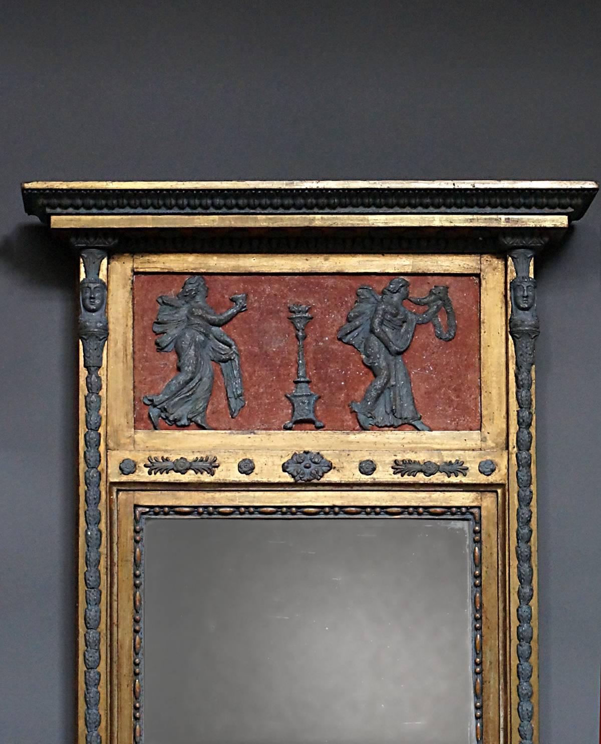 Period neoclassical mirror, Sweden, circa 1820, with original two-part mirror glass and back. The top frieze features two female figures in bas relief bearing symbols of victory. Below the mirror is a panel with sphinxes. The entire frame is