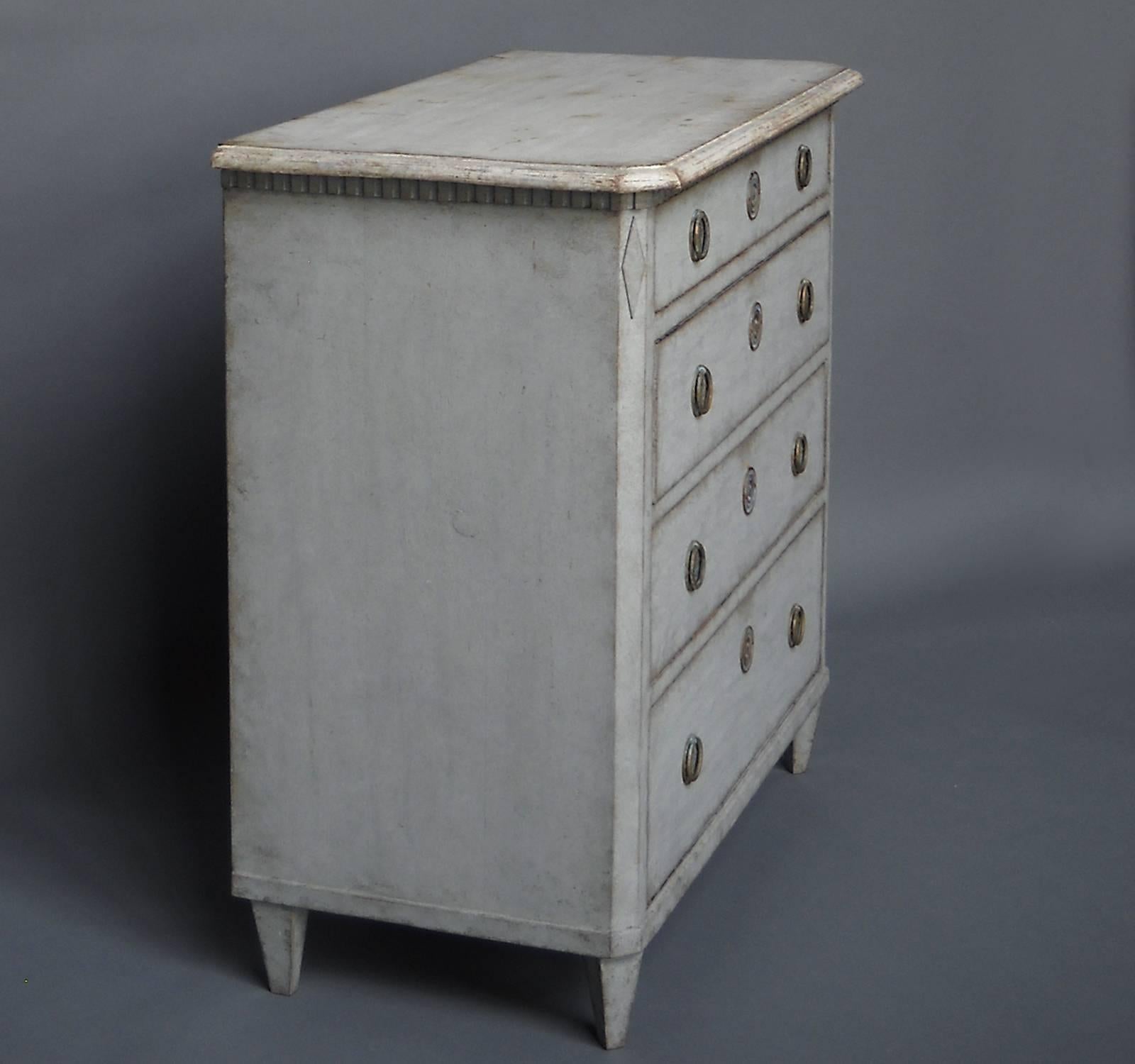 Gustavian style chest with four graduated drawers, Sweden, circa 1860. Dentil molding at the top and canted corners with applied lozenges. Brass hardware.