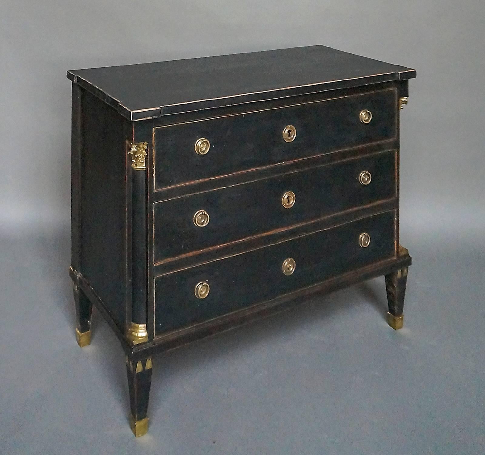 Late Gustavian chest of drawers, Sweden, circa 1780, with deeply recessed quarter-round columns with brass capitals and bases at the front corners. Tapering square legs with applied decorative elements and brass caps.