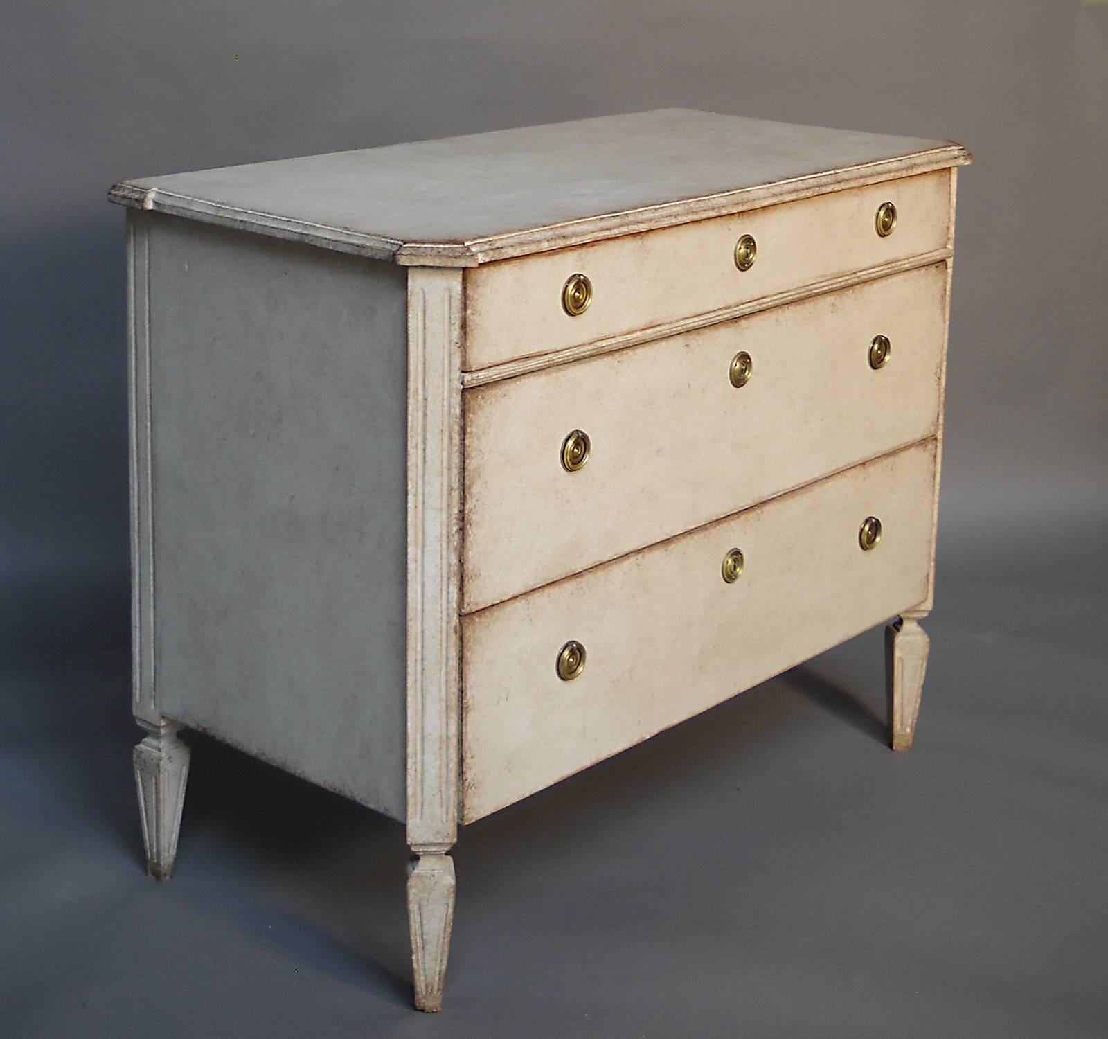 Chest of drawers in the Gustavian style, Sweden, circa 1880. Shaped top, canted corners and tapering legs. Brass hardware.