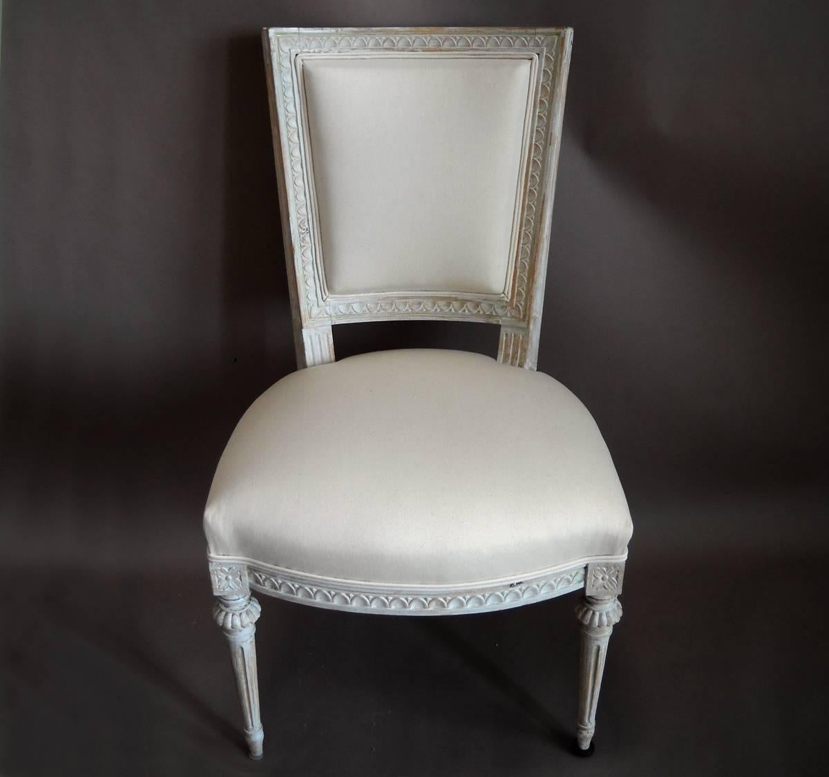 Pair of side chairs, Sweden, circa 1880, with squared backs. Egg and dart molding around the back and seat, with corner blocks carved with rosettes. Newly upholstered in high quality muslin.