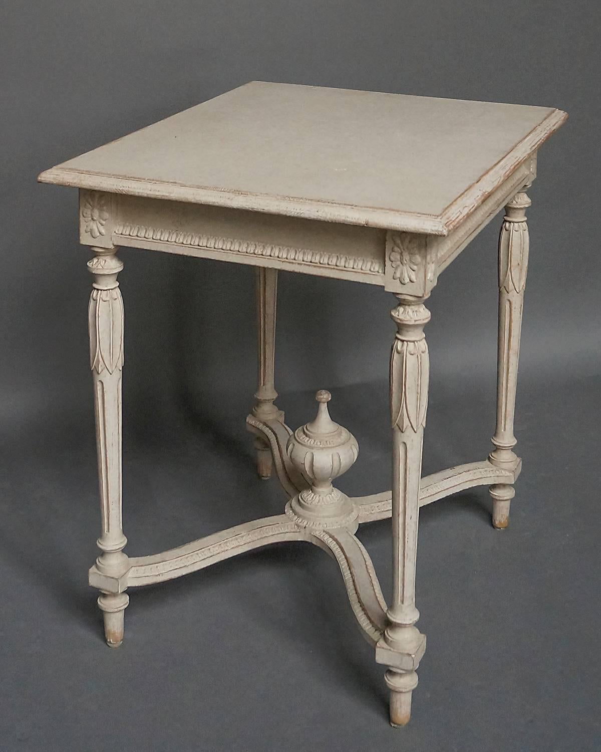 Swedish neoclassical style side table, circa 1900, with exceptional detail. Shaped top with lambs tongue detail on the apron. Applied floral detail on the corner blocks above turned and reeded legs with lotus leaves circling the top. At the center