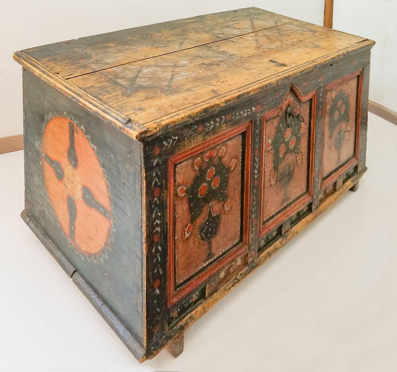 Hope chest from the Tyrol, Austria, circa 1780. The front is decorated with bouquets of roses in footed urns, and the sides are painted with large compass roses. The interior has a lidded candle box, or till, and another unlidded box along the back.