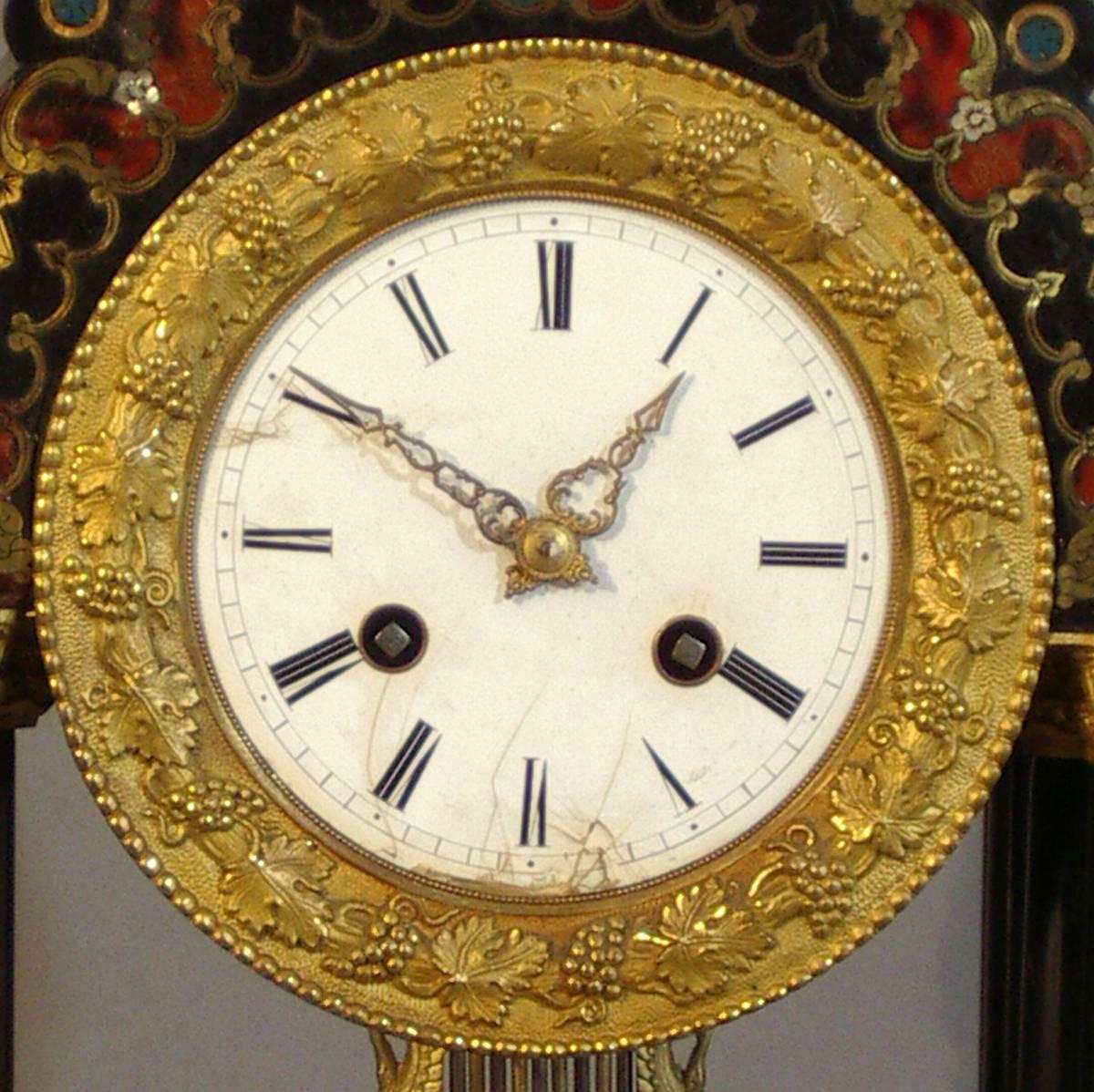 Black enameled mantel clock decorated in the manner of Boulle with polychrome enamels and inlay of mother of pearl. Gilt bronze mountings and enamel dial, France, 19th century.
