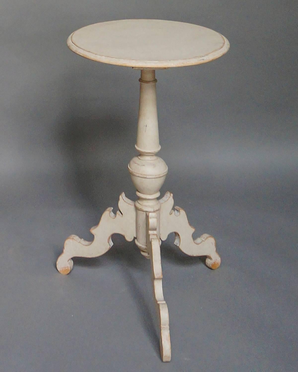 Pedestal table, Sweden, circa 1860, with round top and turned pedestal. The elaborate form of the three scrolled legs is typically Swedish and very decorative. This table would be right at home in any room.