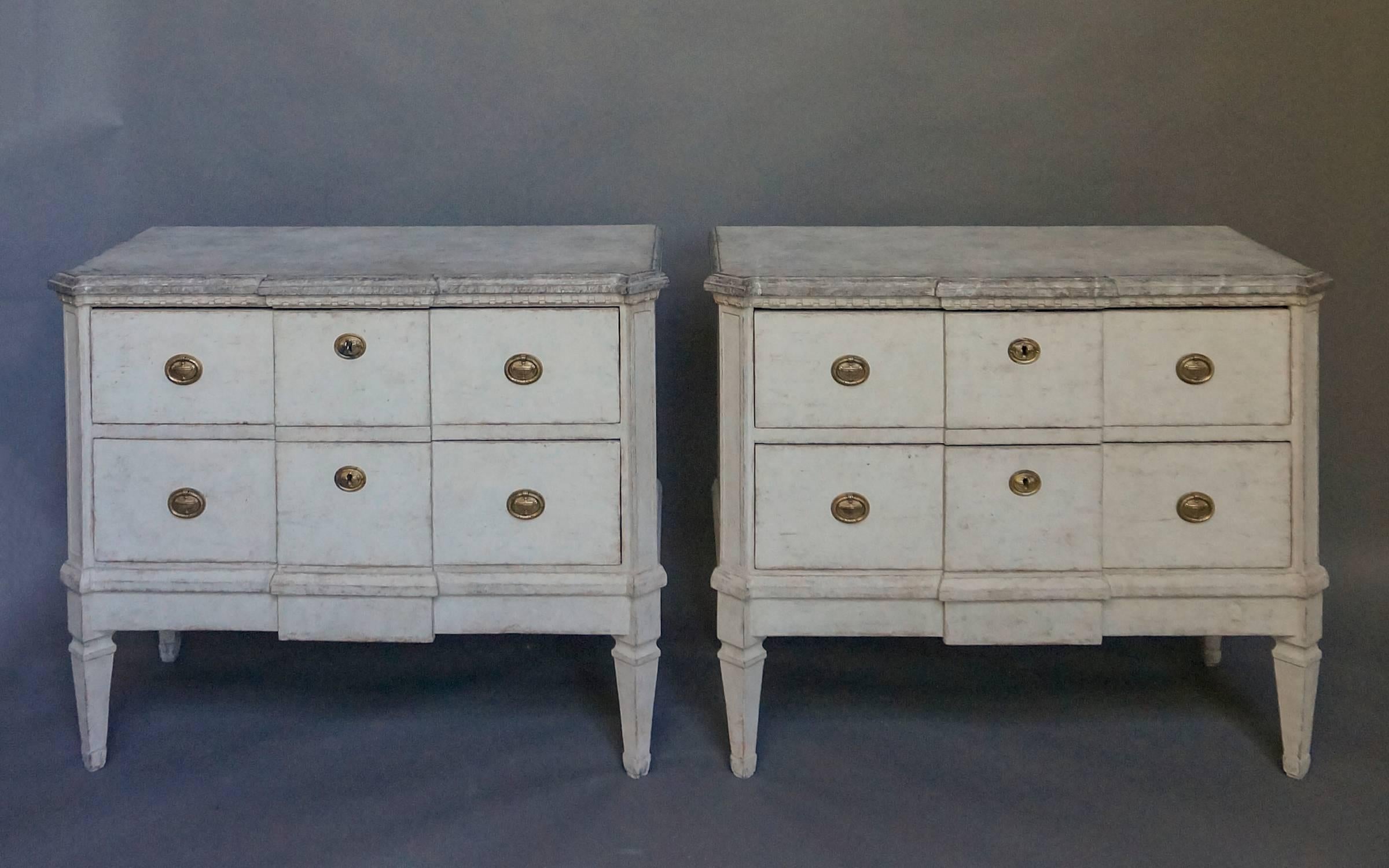 Pair of two-drawer chests in the Gustavian style, Sweden, circa 1840, with marbleized tops, dentil molding and canted corners.