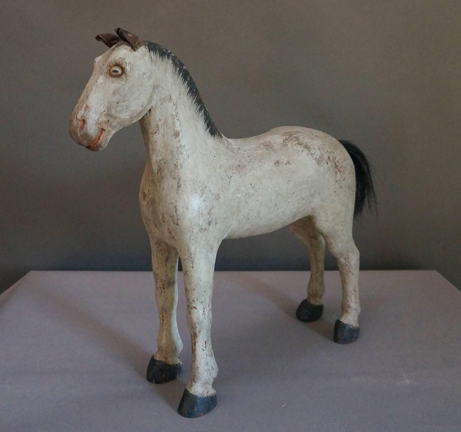 Sweden’s first toy factory was opened in Gemla in 1866, and this sturdy horse was made shortly after that date, circa 1870. He has a friendly, alert expression with perked leather ears and painted eyes. The mane is painted, but his tail is real