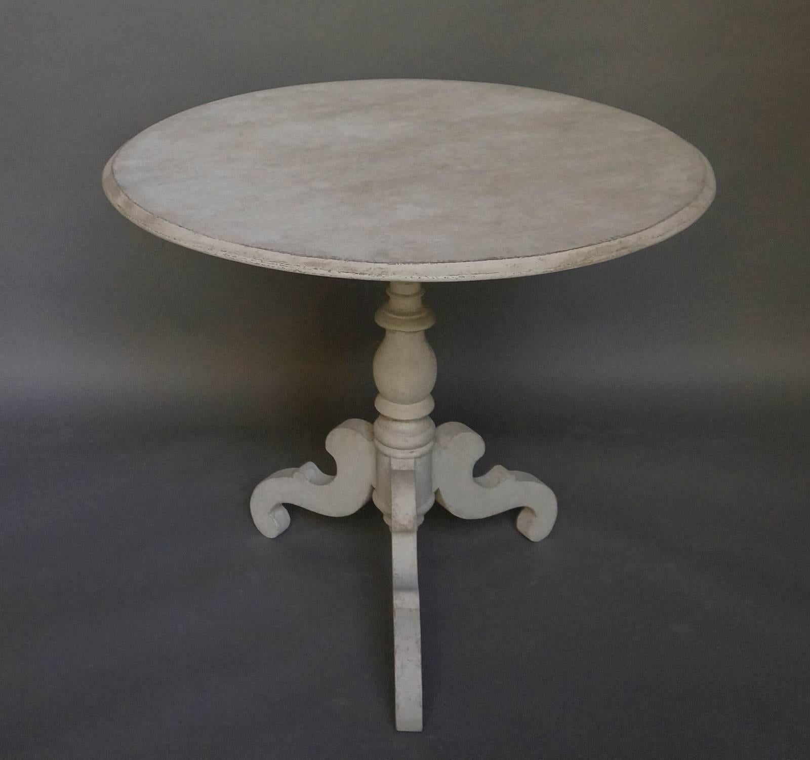 Tilt-top table to seat four, Sweden, circa 1850. Turned base with three shaped legs. Classic Swedish design.