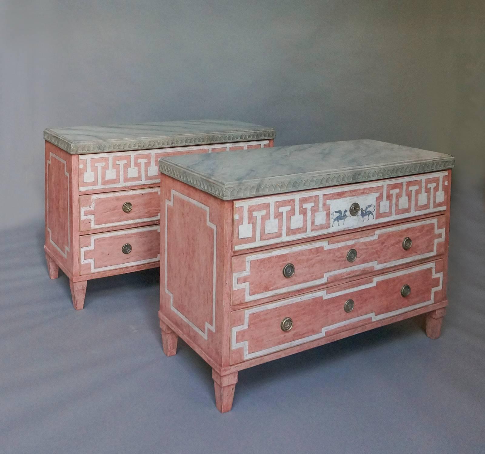 Pair of Swedish three-drawer chests, circa 1880, with beautiful painted surface. Lambs tongue molding surrounds the top painted as Swedish green marble. Each of the drawers and the sides are painted with trompe l-oeil moldings. In the centre of the