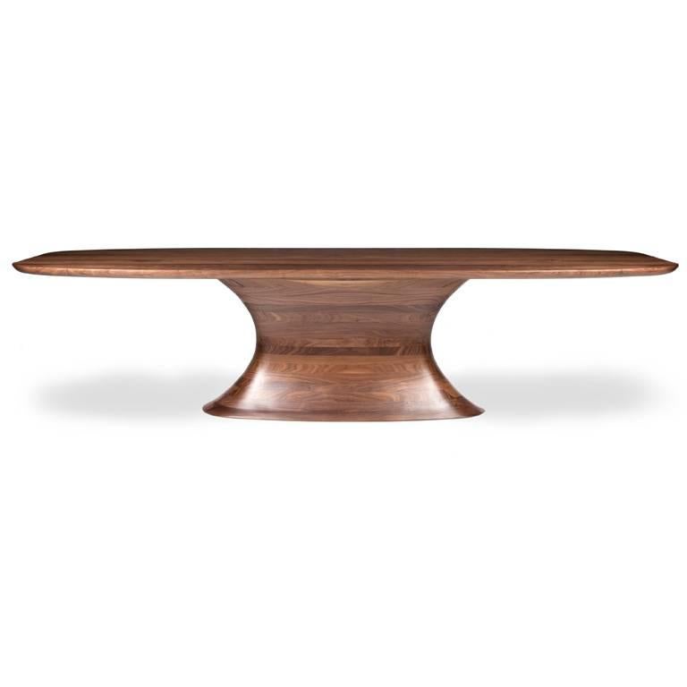 Concave Walnut statement dining table in walnut.

This beautiful contemporary dining table is softened by its organic inspiration. Crafted in the finest black walnut, the skilful hand sculpting reveals a visually striking elliptical concave form,