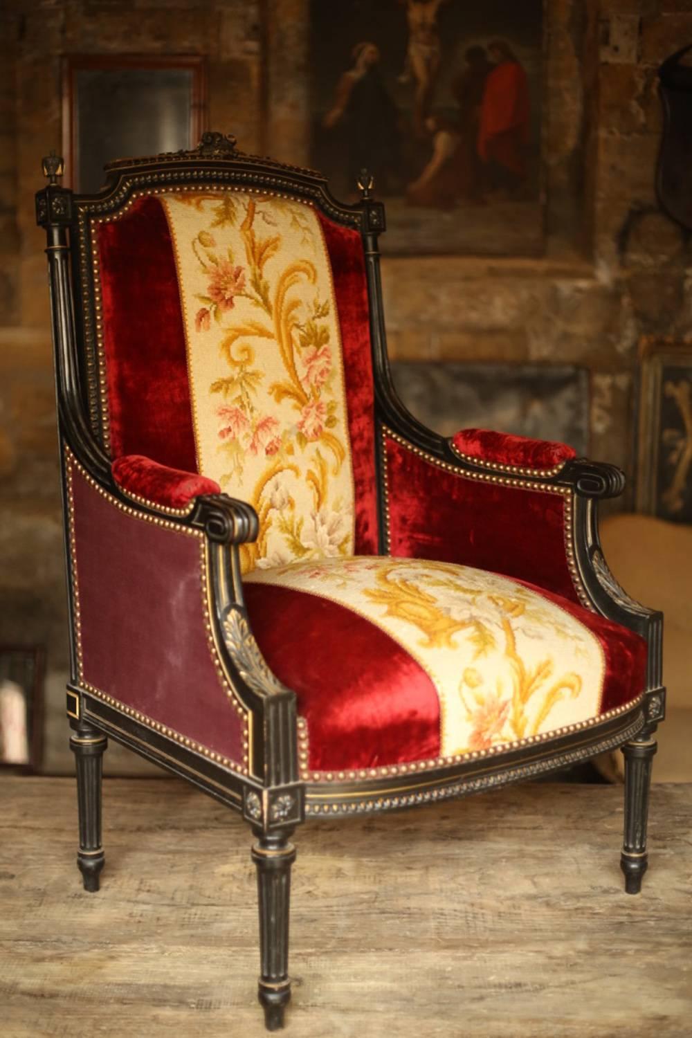 This is an exceptional pair of totally original 19th century velvet upholstered throne chairs. They have a very stylish ebonised and worn gilt frame. Beautifully carved columned tapered legs. Small floral details all-over the frame one small loss on