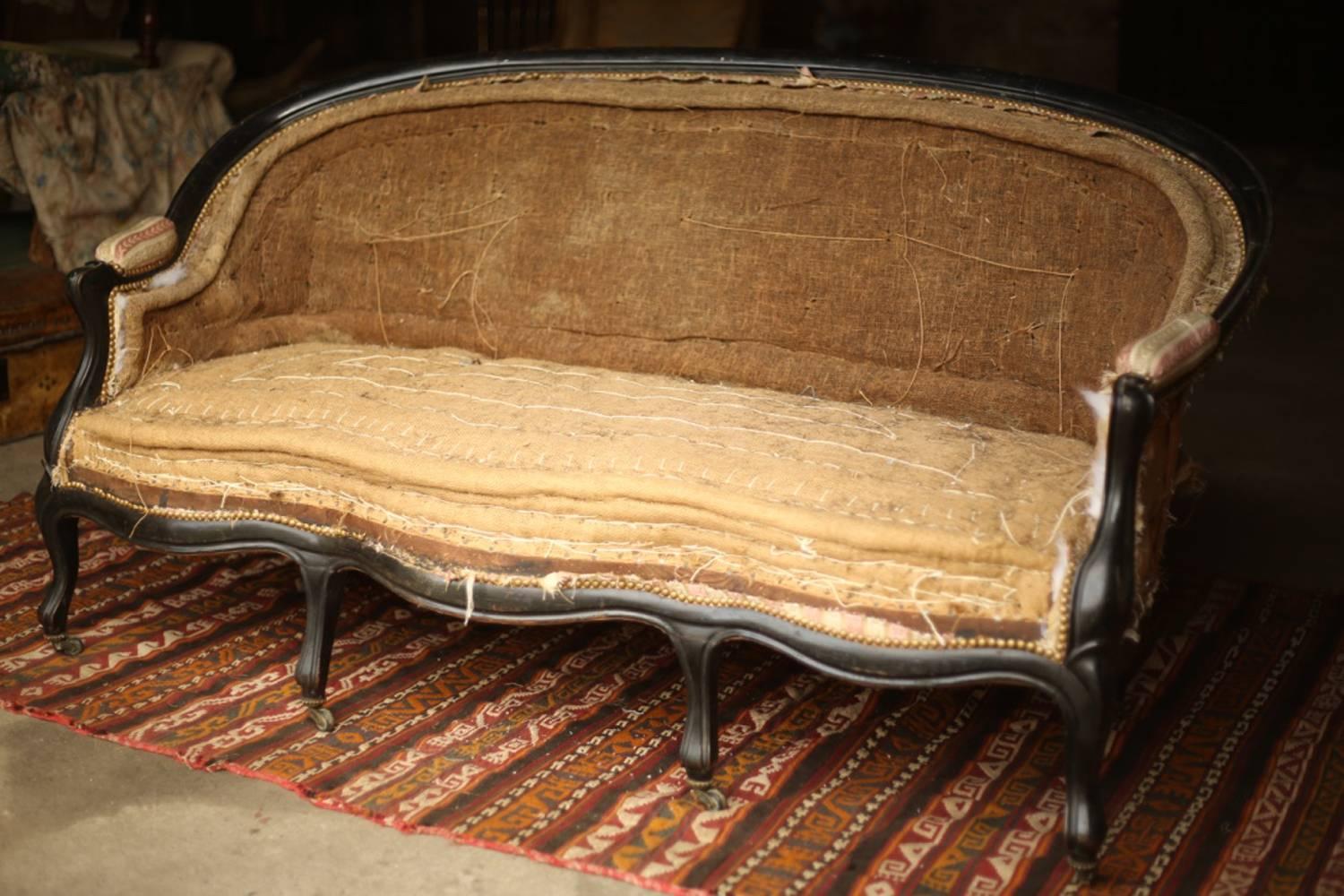This is an exceptional 19th century Napoleon III six legged sofa with a beautiful ebonized frame. The quality of this sofa is superb, all the carved detail on the arms and legs. All six legs are complete with stone casters. There are four at the