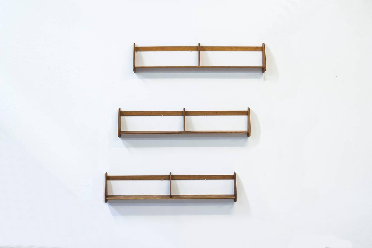 Set of three wall shelves designed by Hans J. Wegner. Produced by Ry Møbler in Denmark during the 1950s. Made out of solid oak.