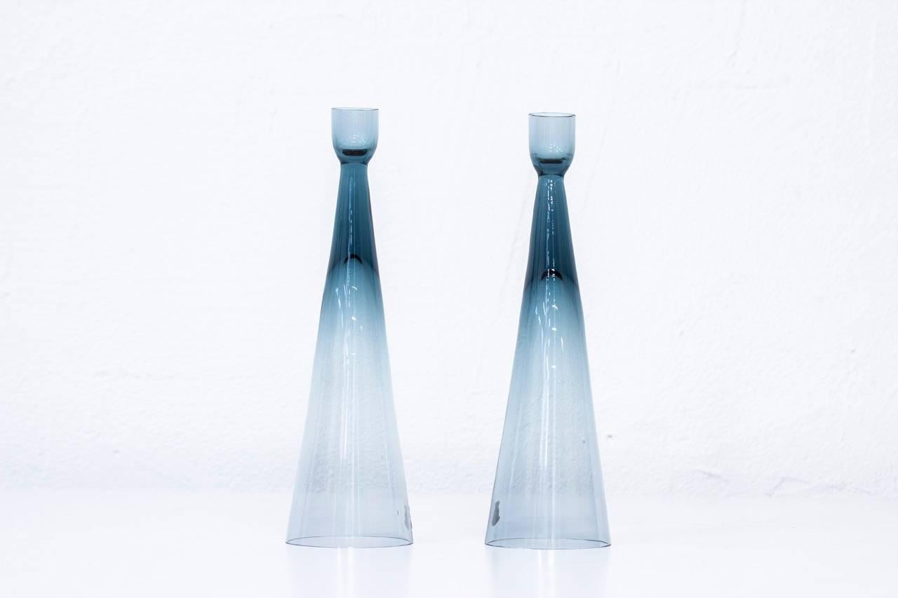 Rare pair of candlesticks designed by Bengt Edenfalk for glassworks Skruf. Hand
blown in Sweden during the 1960s. Excellent condition with original labels.