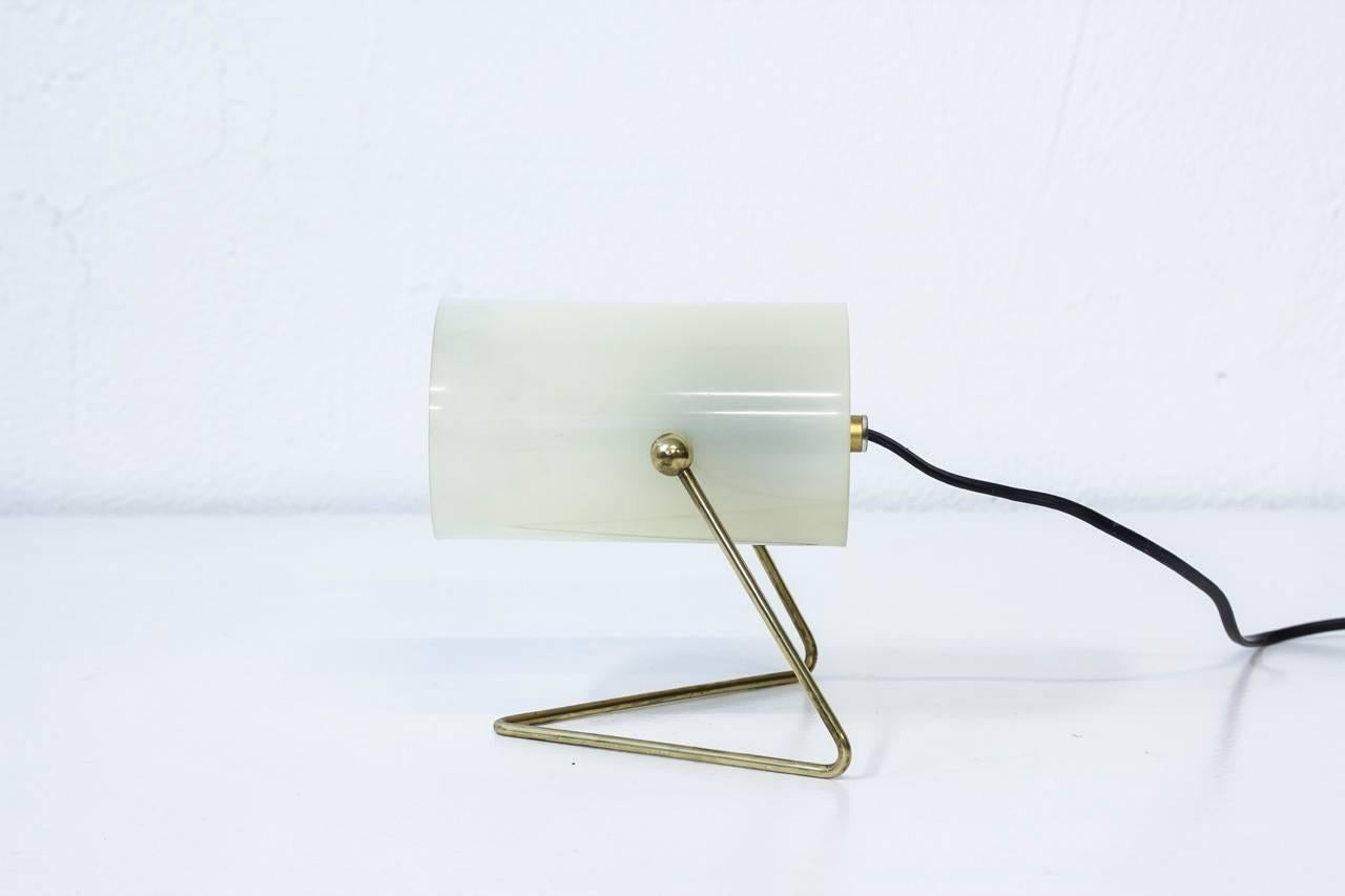Mid-Century Modern table lamp made by Korumo in Finland. Brass frame with adjustable acrylic shade. Usable as wall lamp too.