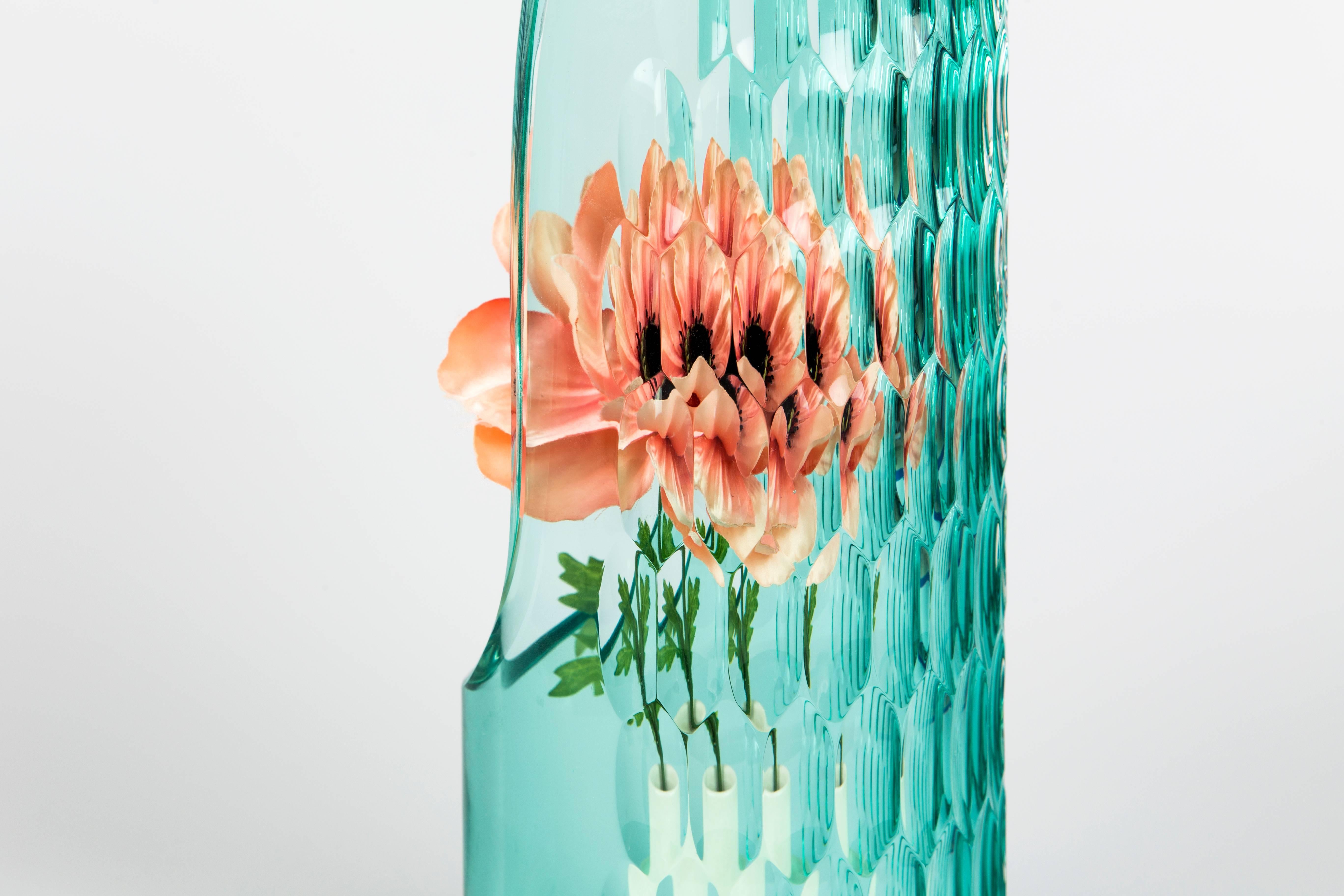 A signature quality of each handcrafted glass vase is the illusion created by its complex pattern of cuts. A kaleidoscopic effect is created within each glass form, so that when viewed from different angles, a single ower placed within it, OP-Vase