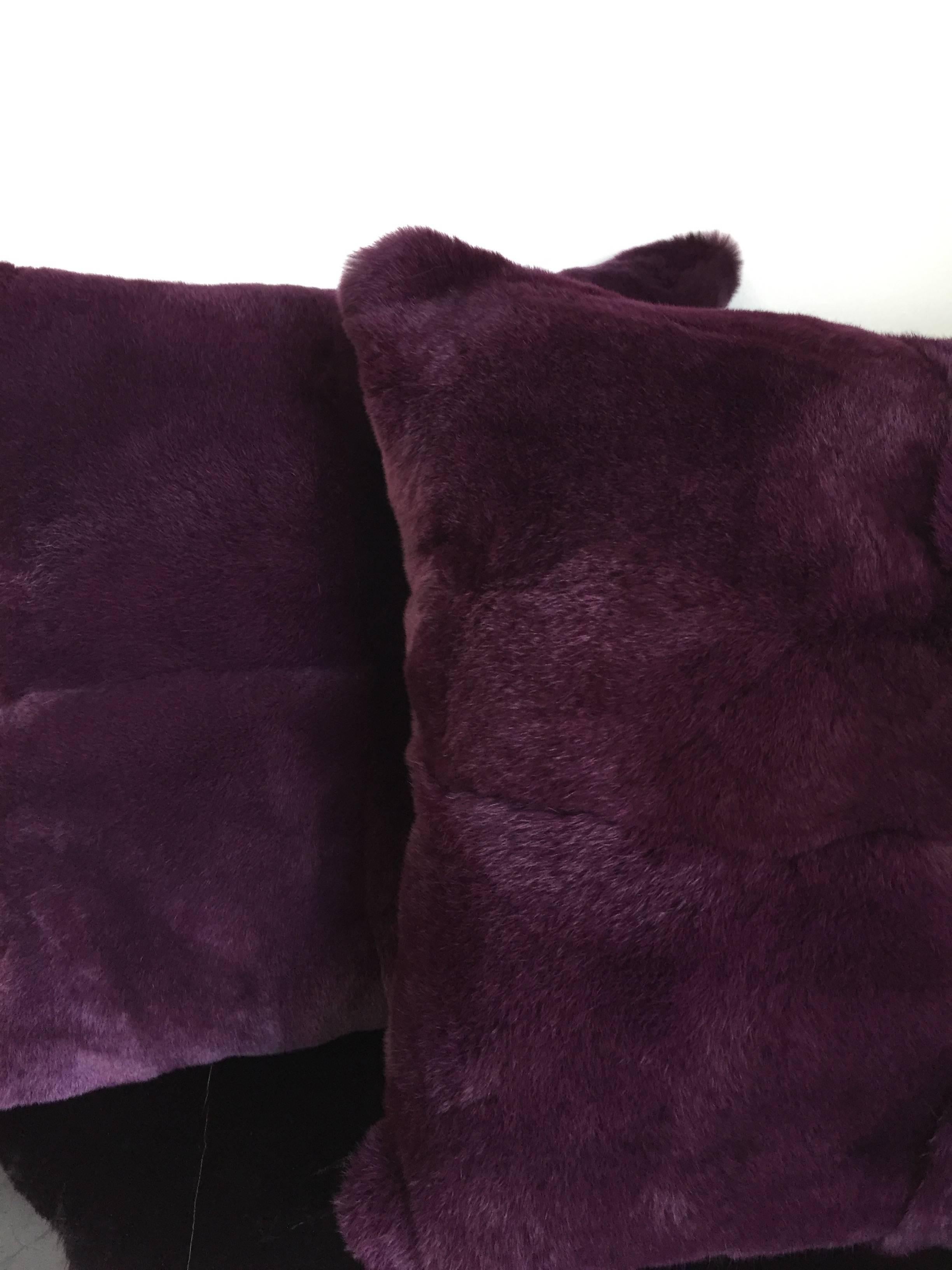 Pair of cushions front panel rex rabbit colour dyed in purple, front panel is made of four skins, back side silk satin colour green, size 50 x 50cm, cushion covers with cotton lining, concealed zipper, feather inner with new feathers, 