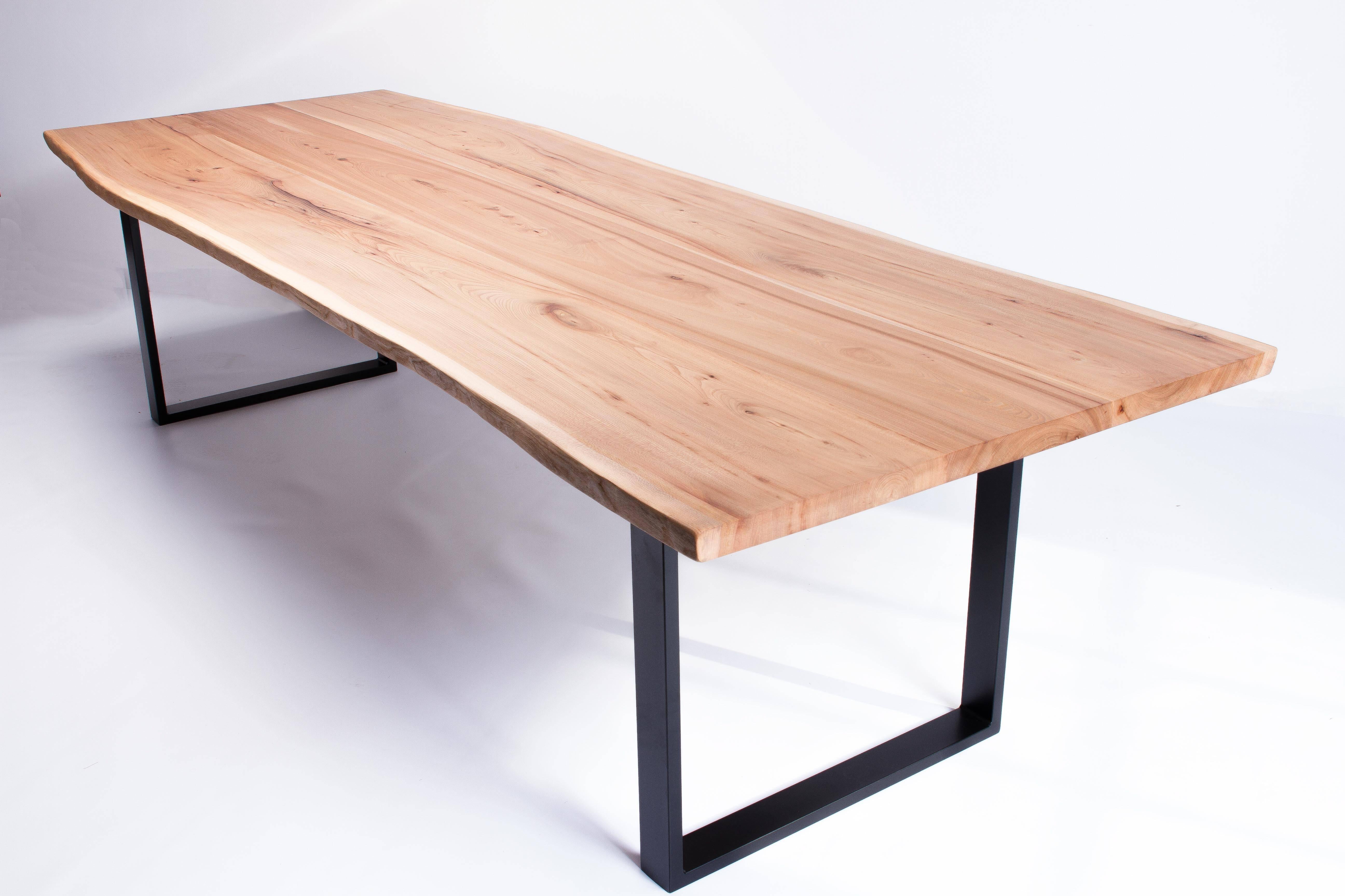 Dining table from sustainably sourced natural live edge slabs of English elm or oak, hand finished in a durable satin finish.
Handcrafted by English Artisan makers, each part is fully customizable.

Sat on hand welded steel box frame legs, shown in