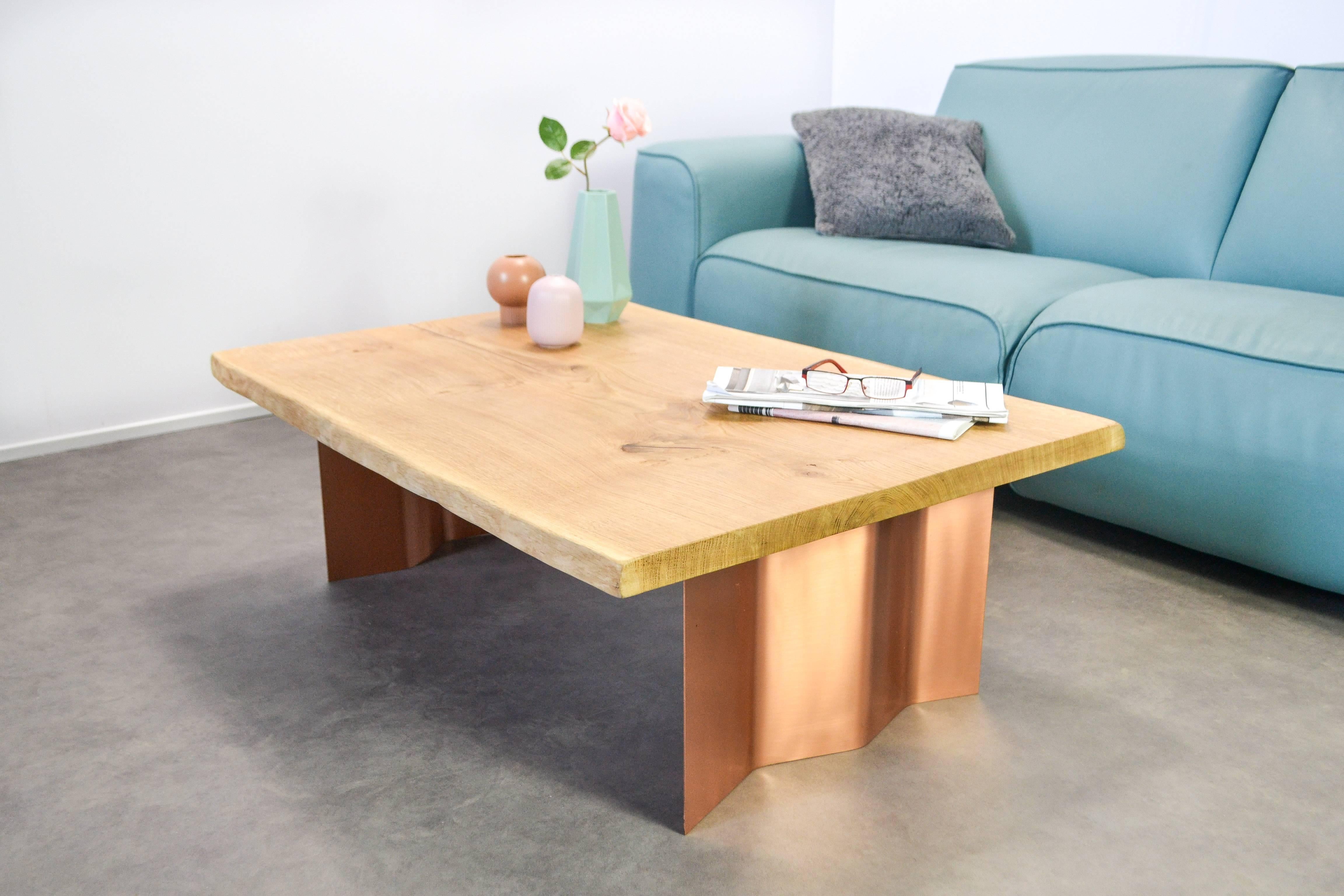 Natural live edge coffee table produced from locally sourced Oak which is sensitively treated to preserve and enhance the natural character, with natural splits infilled with a red resin to complement the modern wave base. 

The copper wave legs are