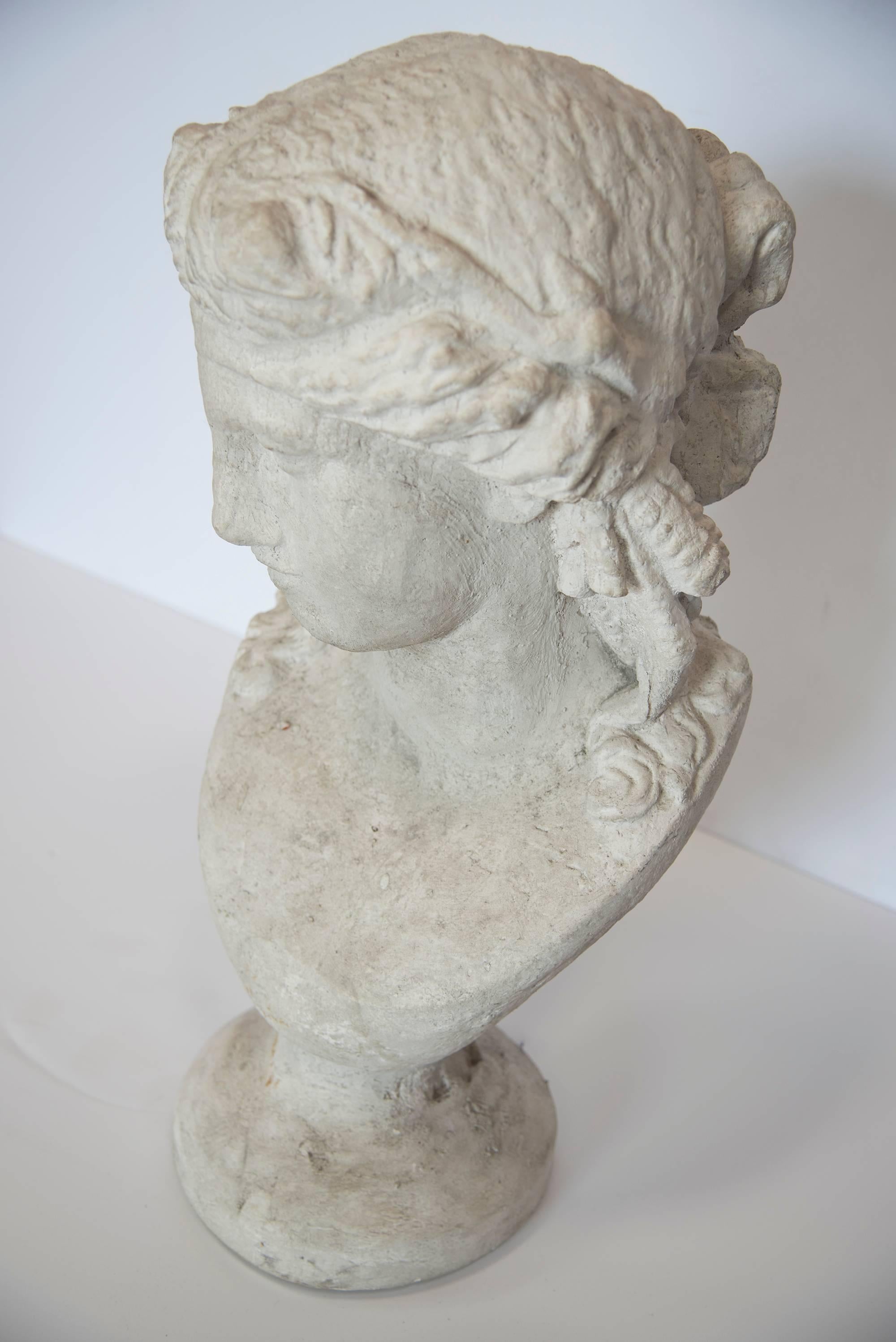 A lovely, detailed and exquisite plaster bust of a woman. Refined features and intricate hair details make this figure a perfect showcase piece.