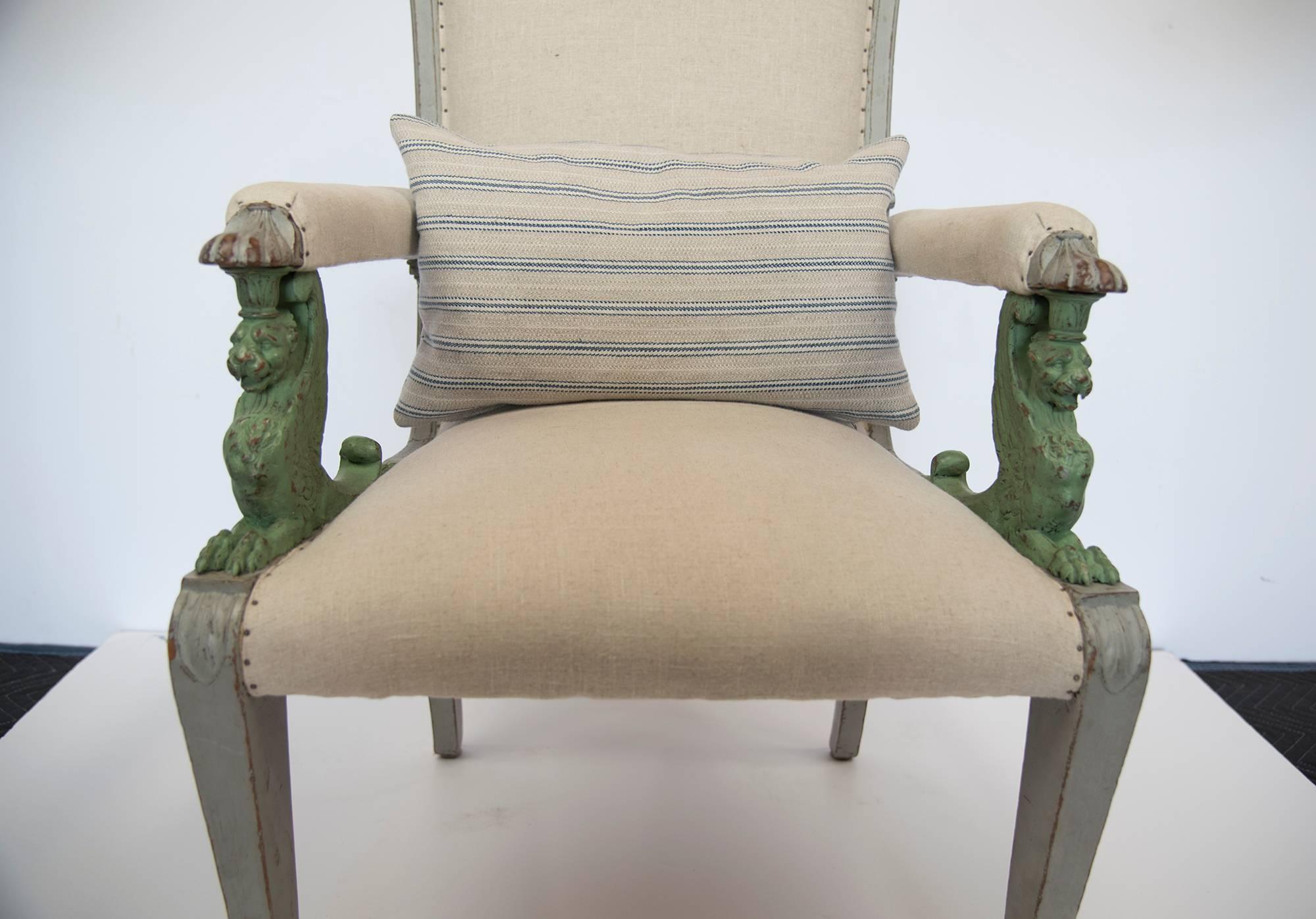 A very unique and perfect condition Swedish armchair with green trim and gargoyle carving on the arms pillow in striped cotton or linen fabric is included. A very comfortable and extraordinary conversational piece to add to your inventory.