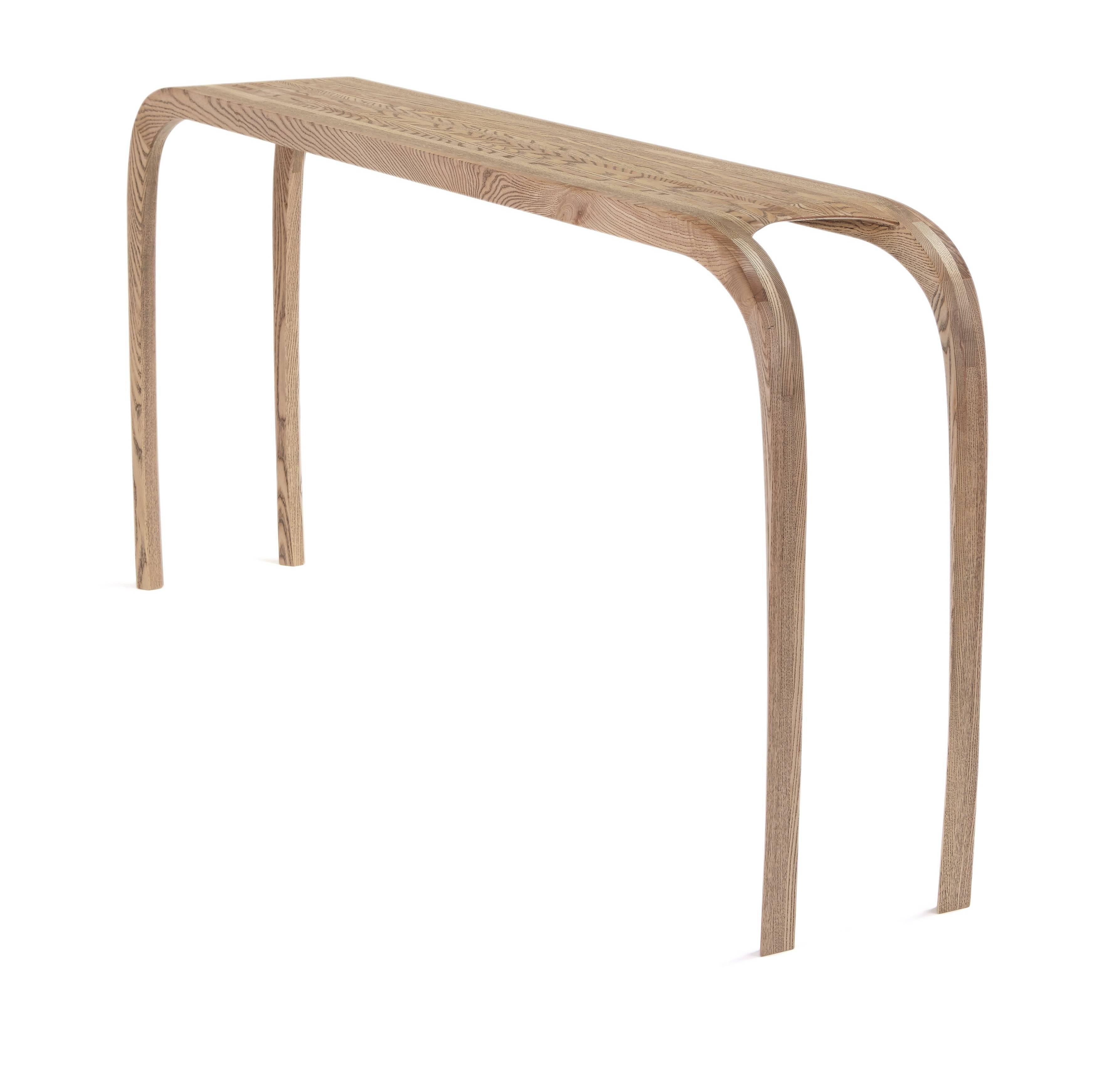  The console tables curved legs were designed to have a animal like posture and balance that flows up through the leg into the top.
The strips of ash are carefully arranged and laminated together to create a interesting visual contrast between the
