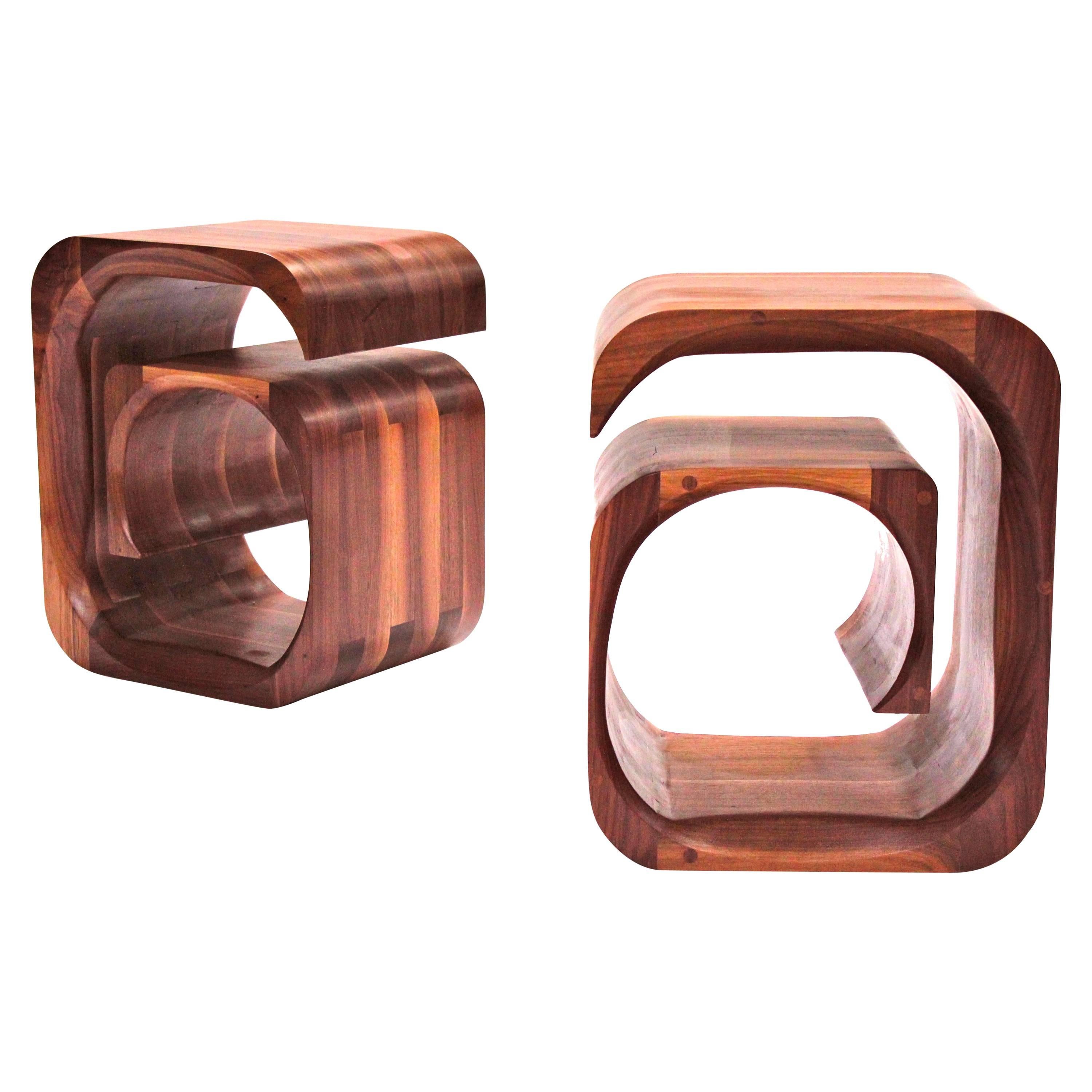 A pair of sculptural bedside Tables in solid walnut by Jonathan Field