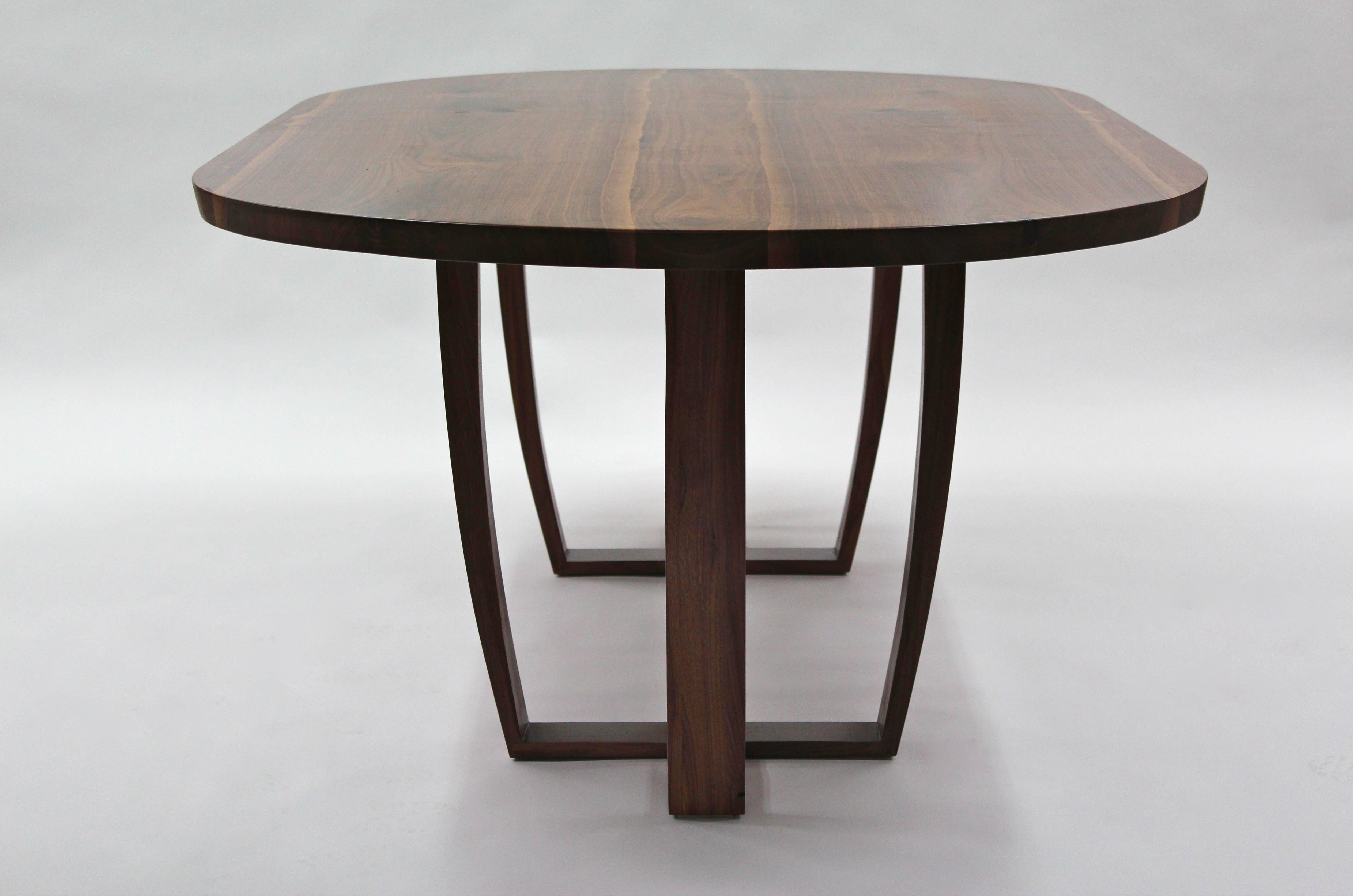 The top is made from two pieces of inverted, mirror image (bookmatched) 
American black walnut carefully cut into a central slab of walnut, the shape of the logs live edge is inset into the table top,  giving visual reminder of the tree that it came