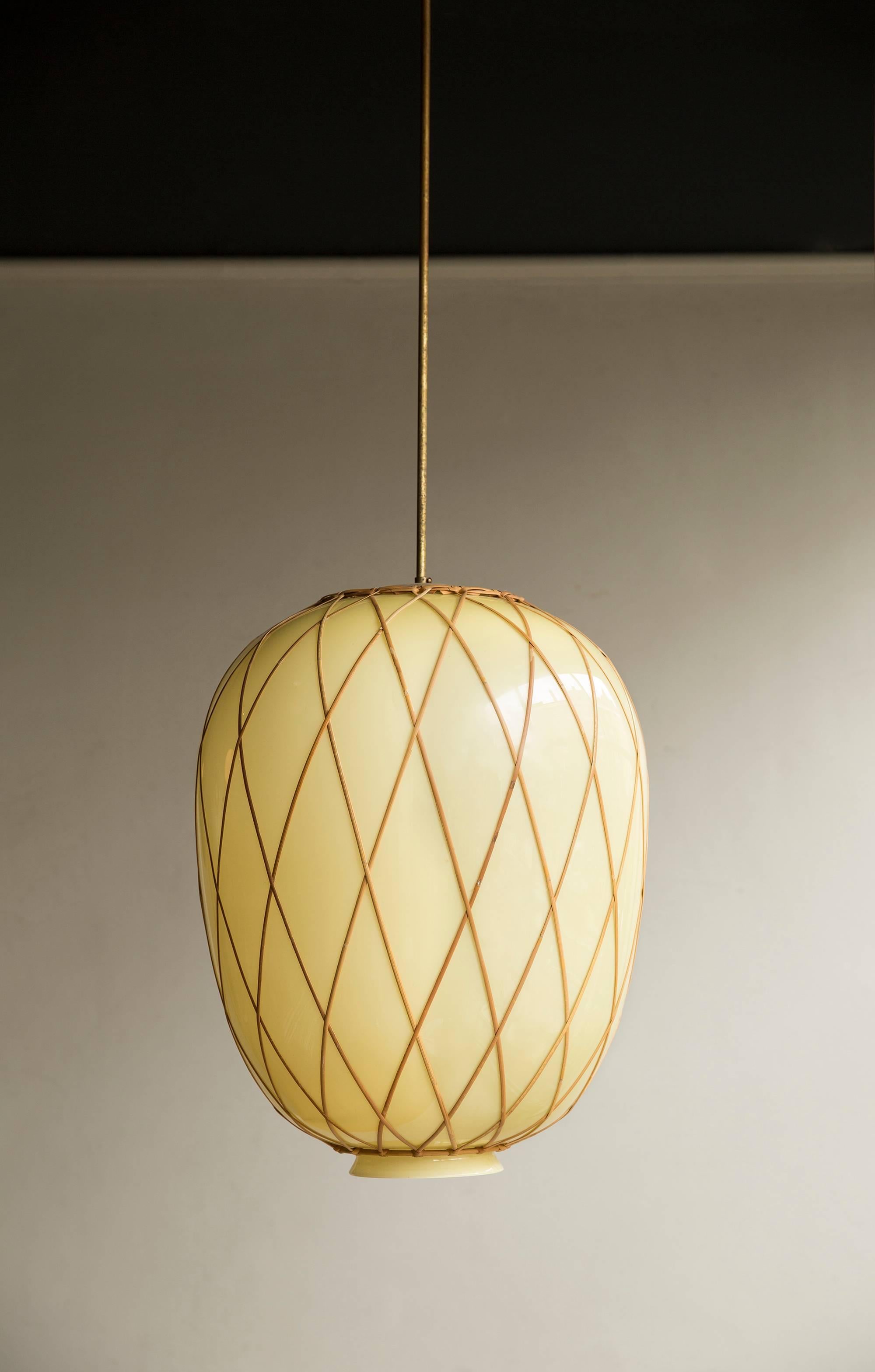 A particularly large Swedish glass pendant with cane trellis wrap suspended by its original 1.5 metre gold lacquered steel rod, designed by Carl Westman for the Norrköpings Lasarett, circa 1927.

Carl Westman worked primarily as an architect and