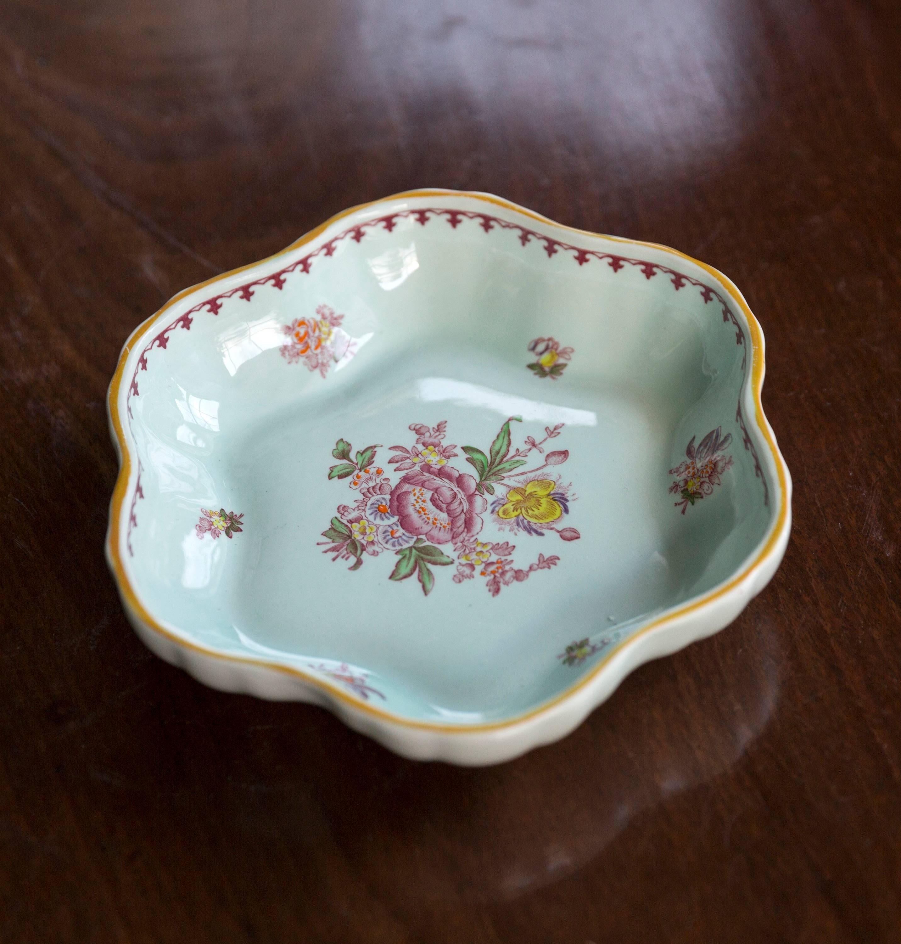 A small and rare hand-painted Adams ‘Calyx Ware’ ceramic dish with scalloped edge, the duck egg blue ground with floral transfer designs and hand-painted detailing, English, circa 1963.

The Adams pottery was active in Staffordshire as early as