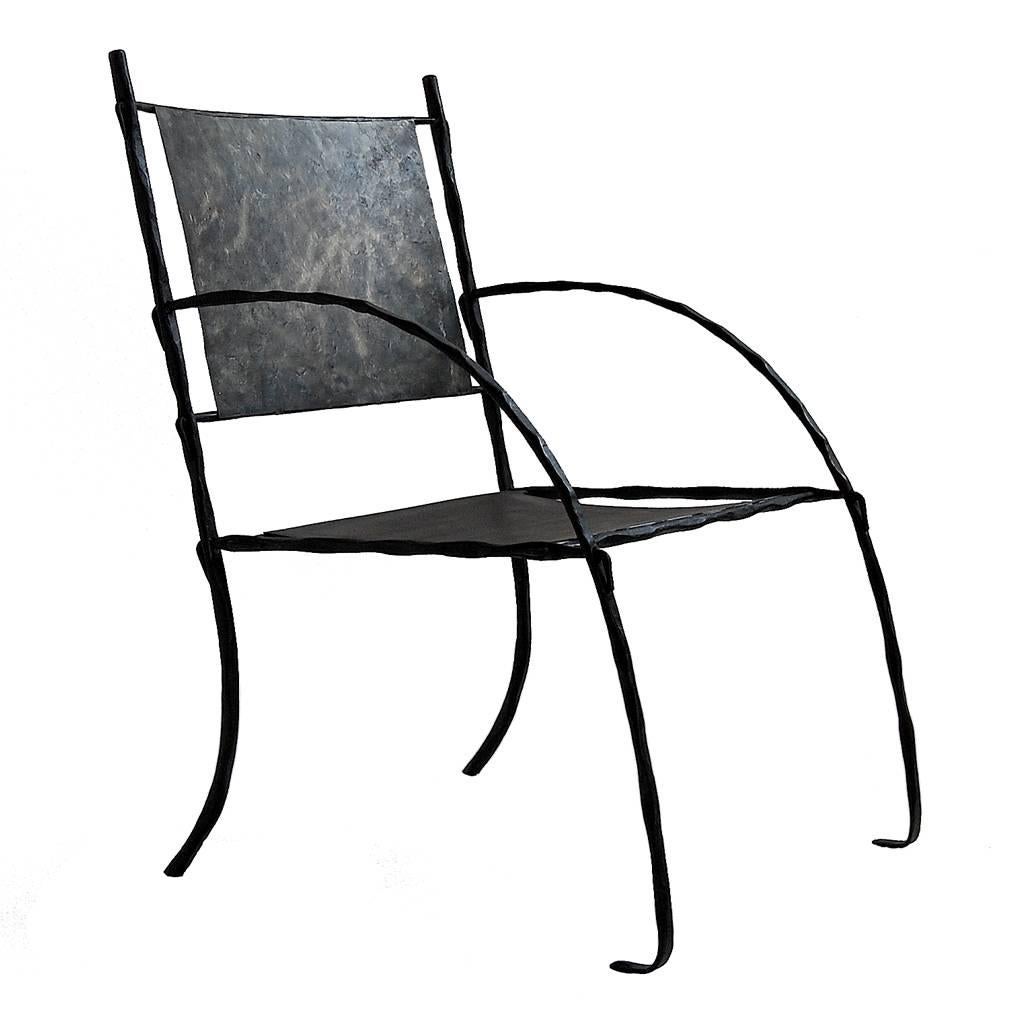 A handmade wrought iron armchair, intended for use indoors. 

Inspired by the sculptural aspect of Giacometti. 
This glamorous armchair is amply proportioned with sleek curves, that allows this elegant piece to work in any interior space.