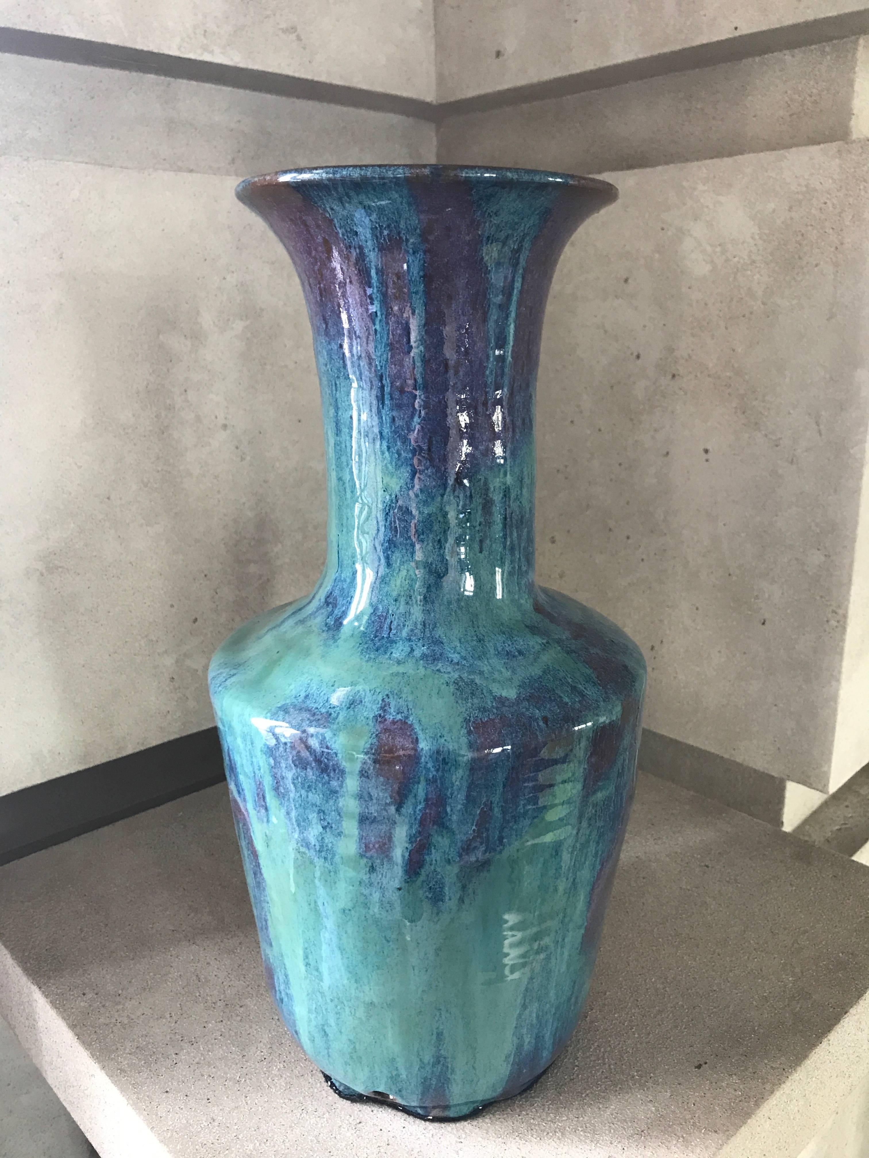 A handmade ceramic vase with an elongated, fluted neck in a custom sea green, violet and mauve glaze.
This stunning vase is suitable to be wired to become a lamp. 
This contemporary vase has been custom designed and makes a sensational statement