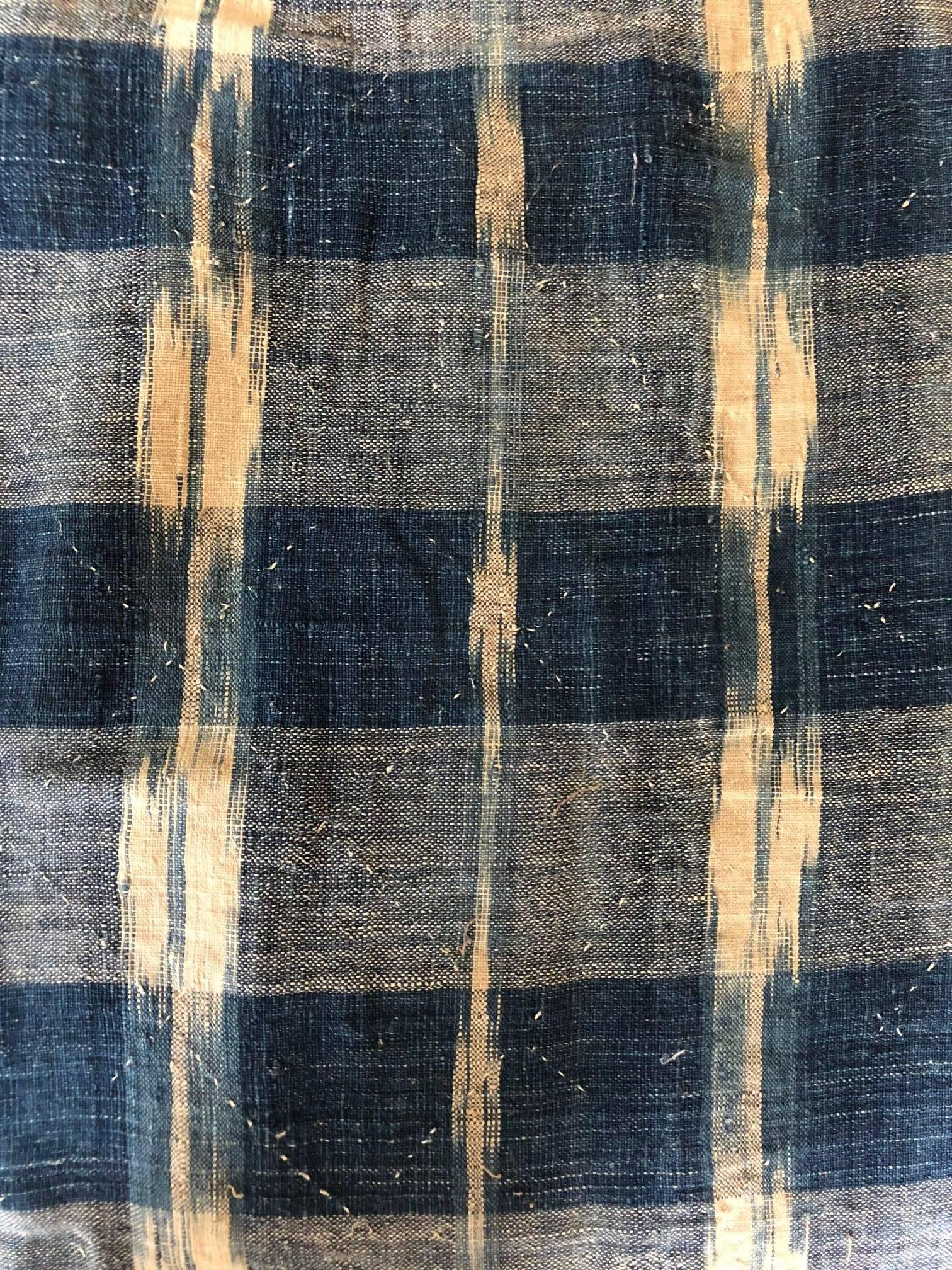 An early 18th century French home spun, handwoven indigo dyed antique linen Ikat. This piece is hand-stitched in a diamond pattern. Handmade textile, antique fabric lined. This piece is sewn together in to parts in opposing Ikat directions.