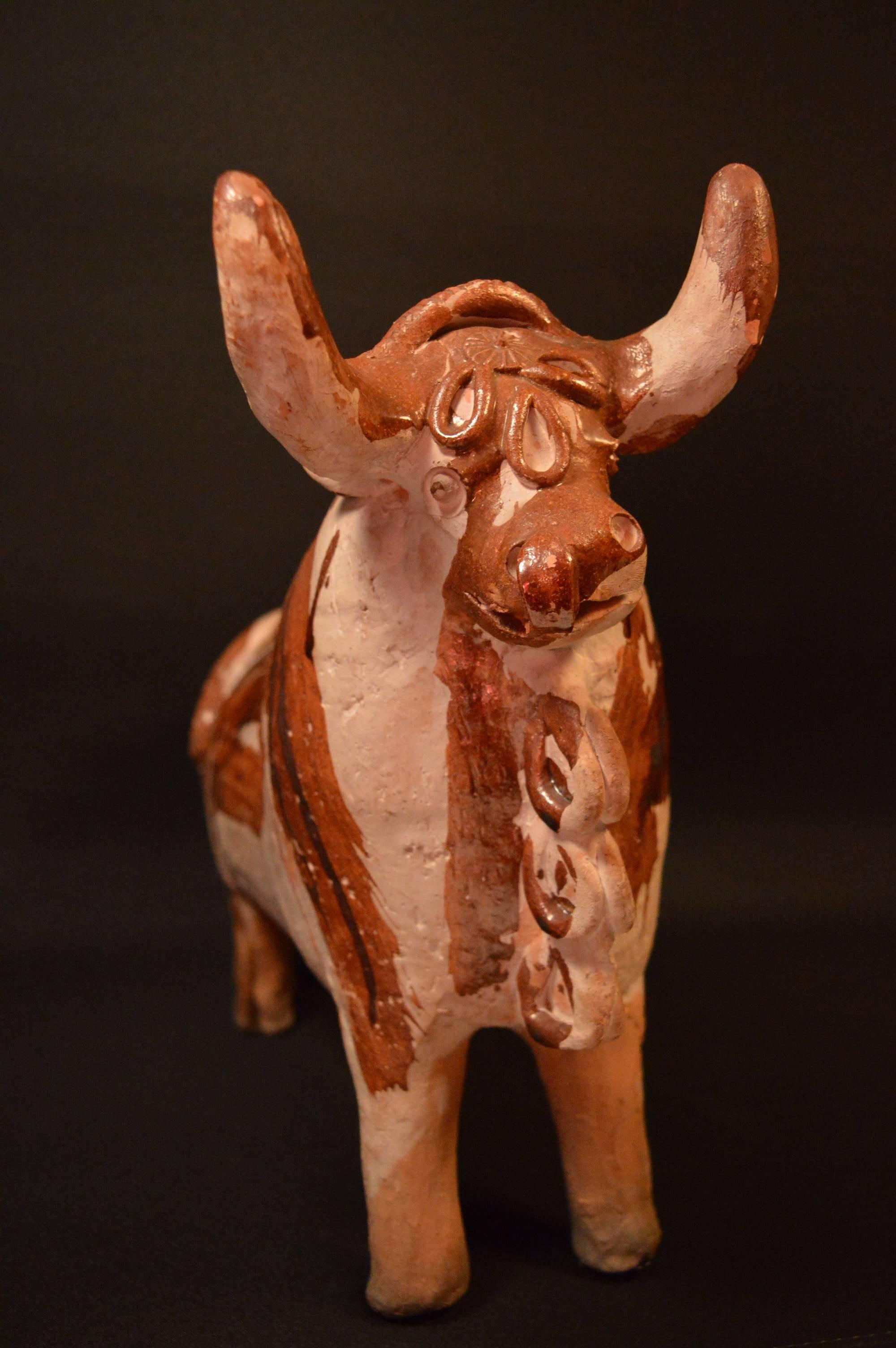 Antique jug clay in style of a bull from Peru.

Also known as Torito de Pucara, they are placed on the roof for good luck, fertility (of crops and livestock) and to bring prosperity. They are typically given as presents for extra luck and pretty