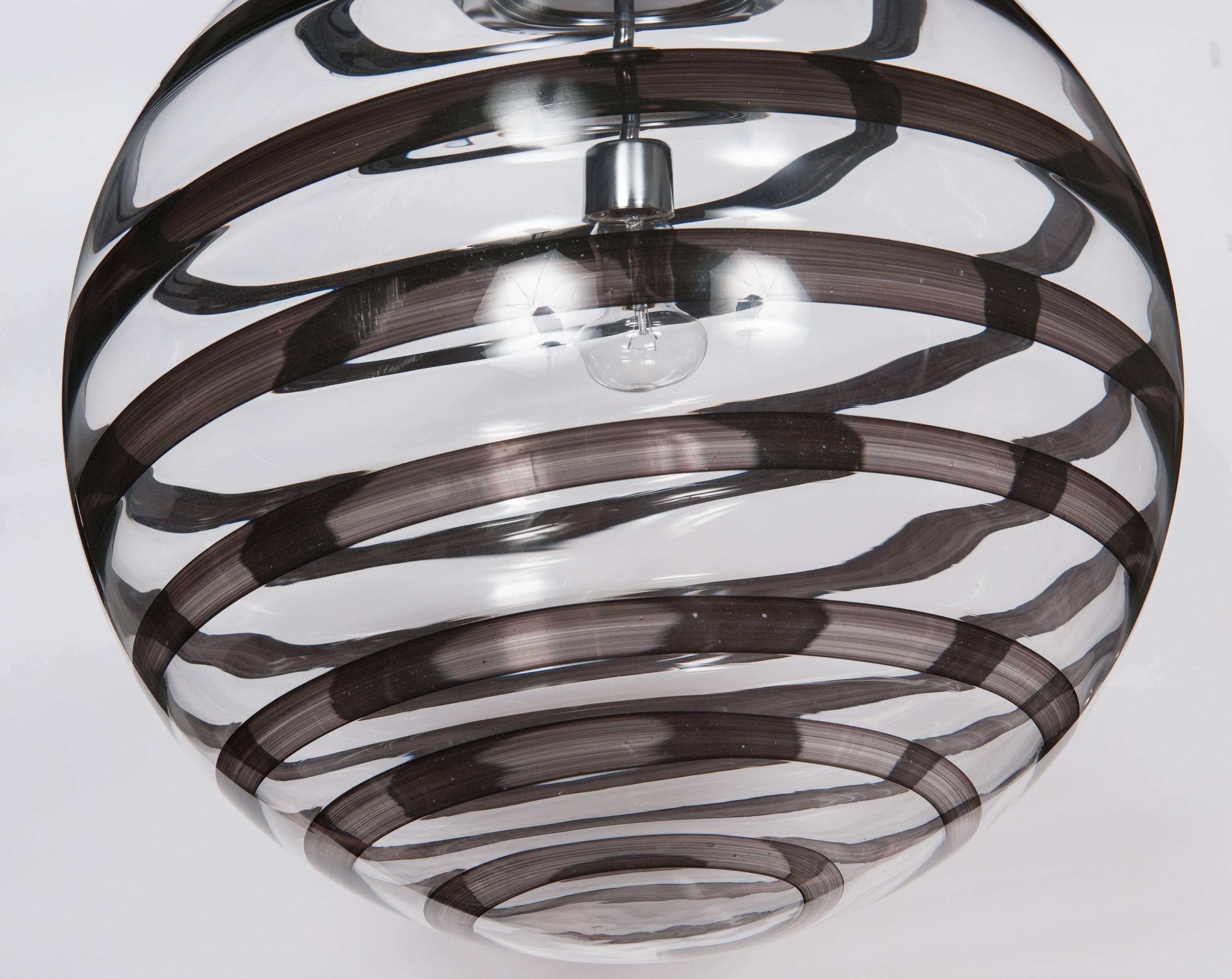 Custom handblown Murano glass globe pendants in black swirl accent.