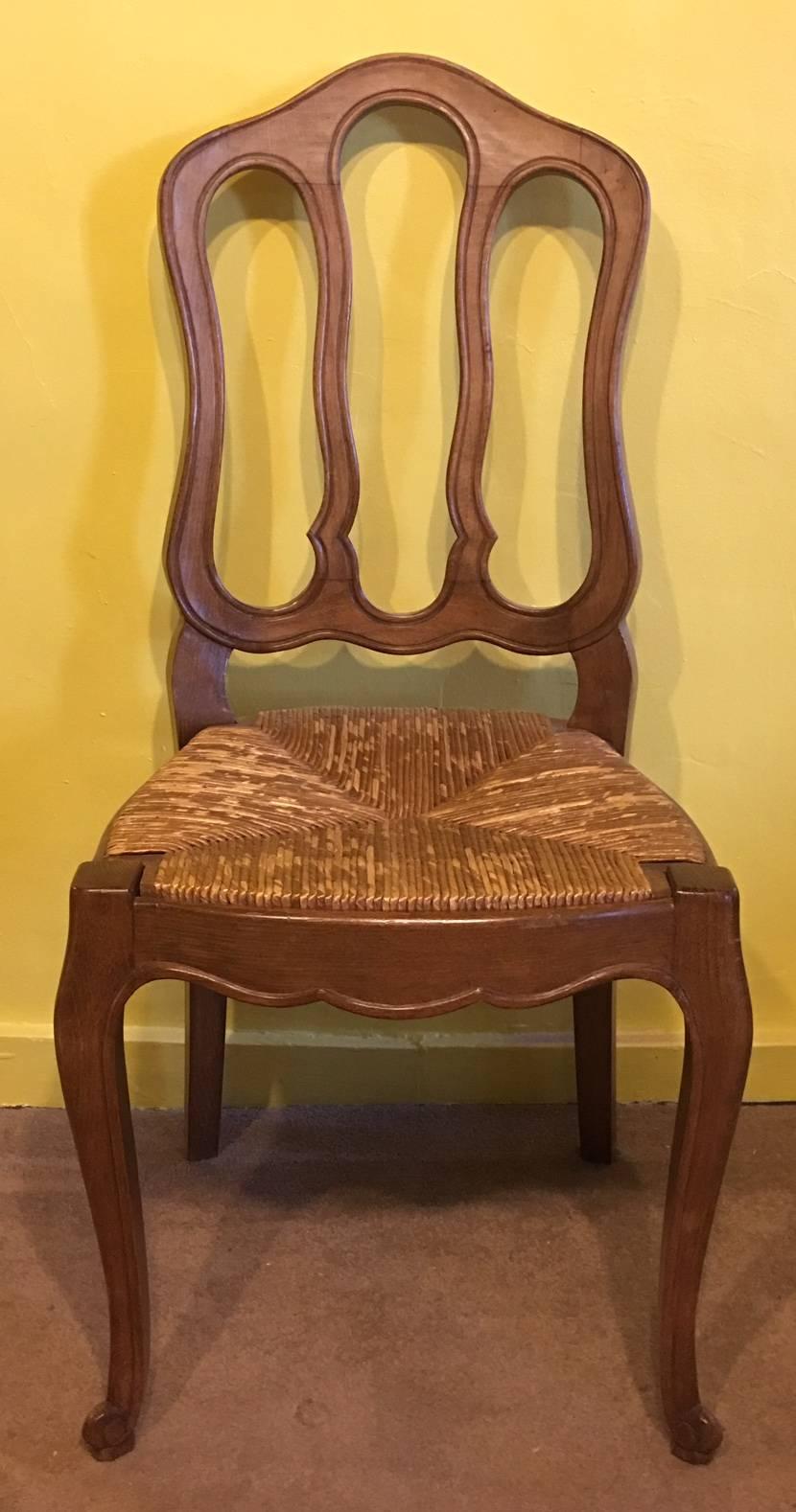 A set of six Louis XVI style fruitwood dining chairs with shaped back over rush drop in seat raised on cabriole legs,
circa 1920.
 