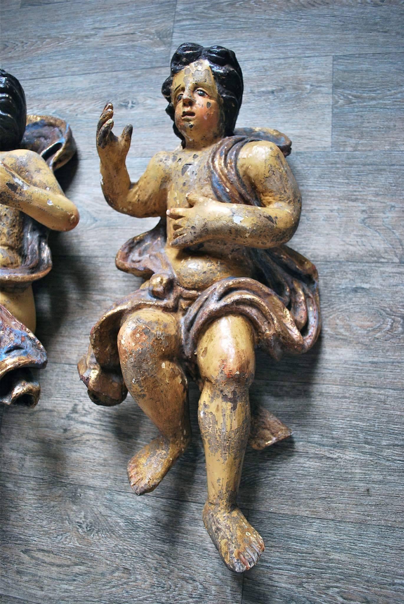 Pair of interesting looking gilt and polychrome wood sculptures of cherubs. 17th Century or earlier. 
Height 60cm.