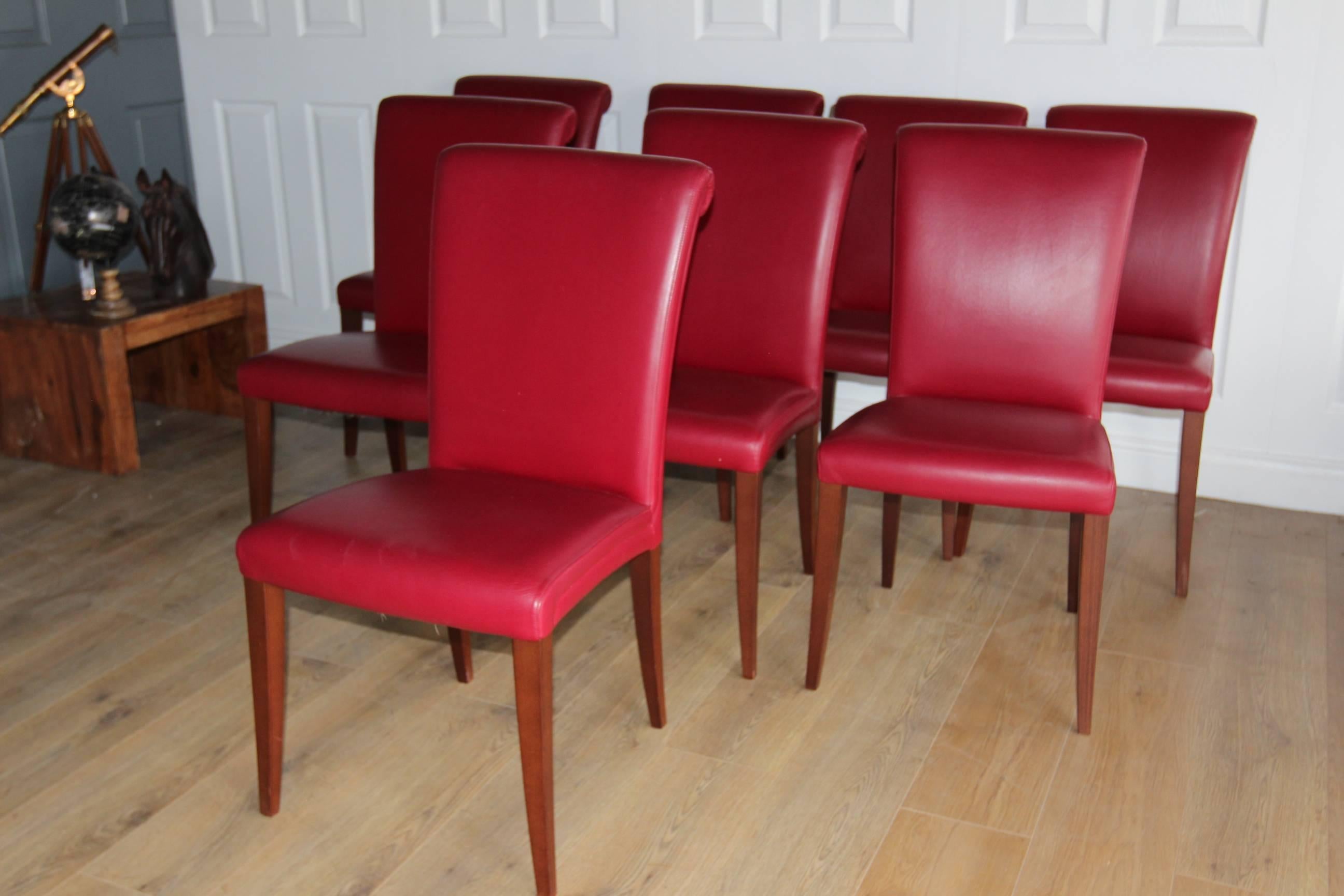Poltrona Frau 'Vittoria' set of eight dining chairs in claret leather
with stained beech legs
approx £7200 new today
current model
in very good condition

The Vittoria series is known for its unusual back, which finishes in an elegant swirl