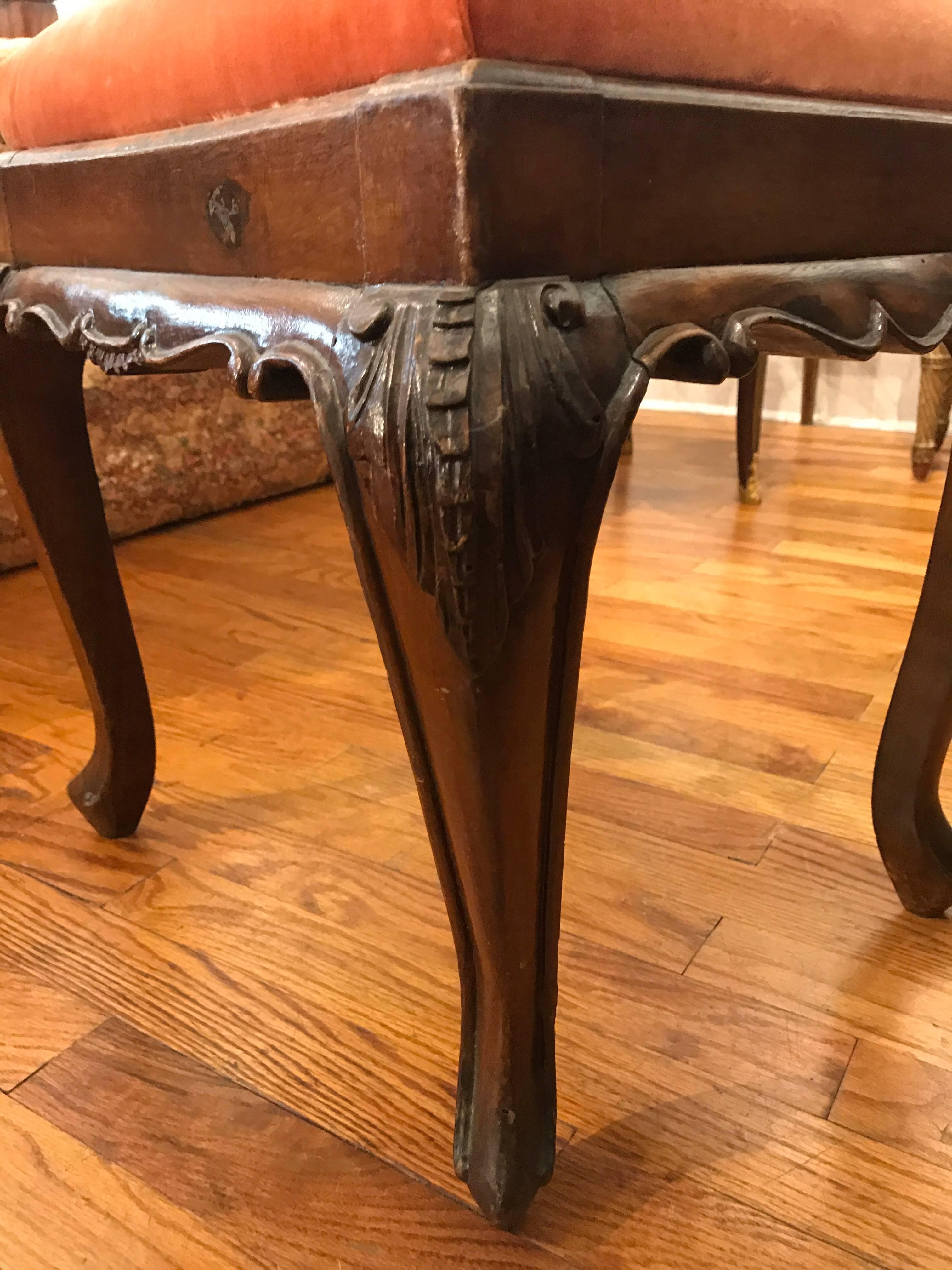 Perfectly sized, Mid-Century 18th century, Italian, carved walnut wood stool, upholstered in an apricot-colored velvet. Made in Parma, Italy.

Provenance: L'Antiquaire & The Connoisseur.