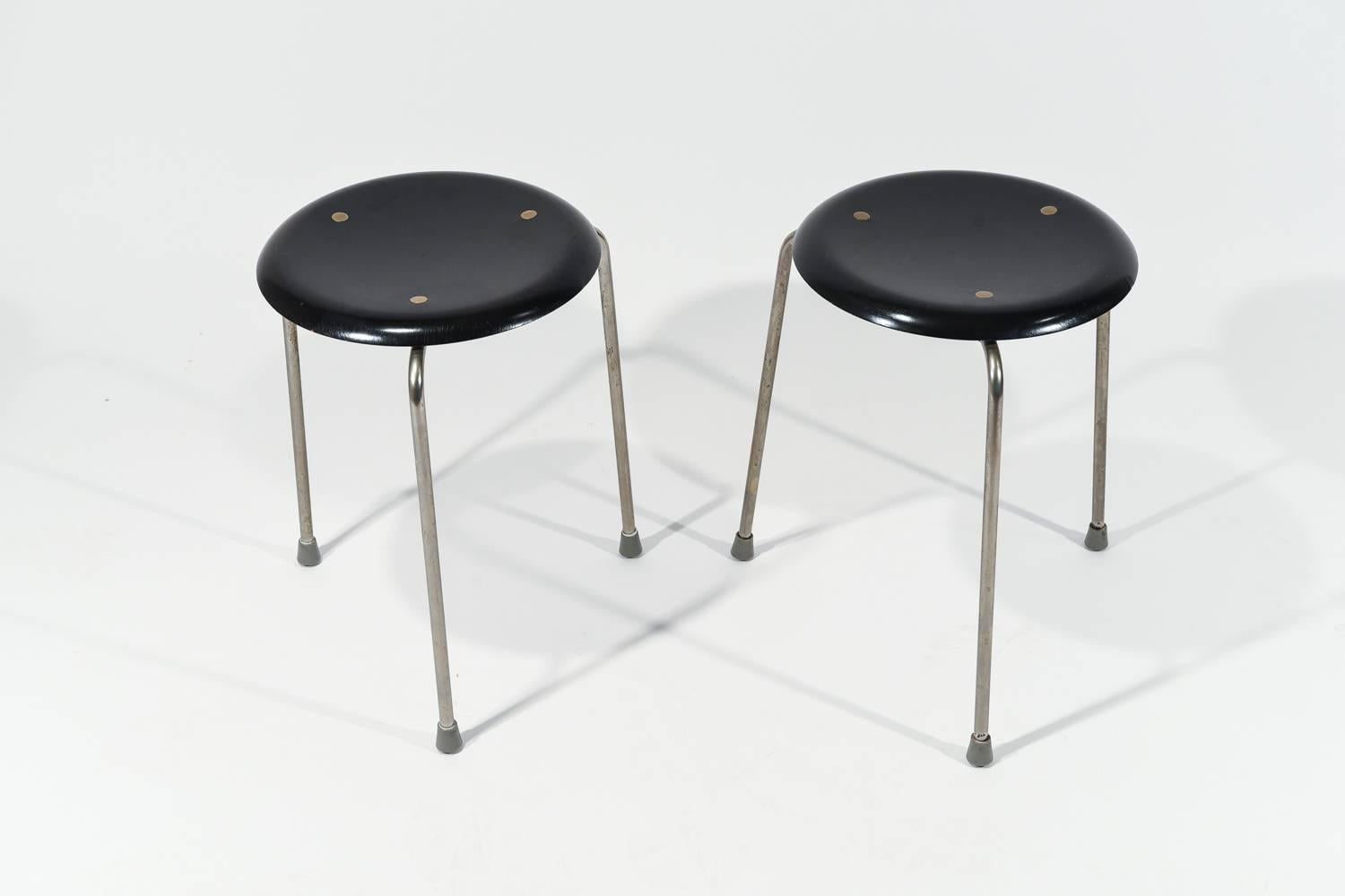 The Danish Mid-Century Dot stool, model 3107, was designed by Arne Jacobsen in the 1950s and manufactured by Fritz Hansen in the 1960s. It features a three-legged design, later developing into a four-legged design. It captures a simple yet pleasing