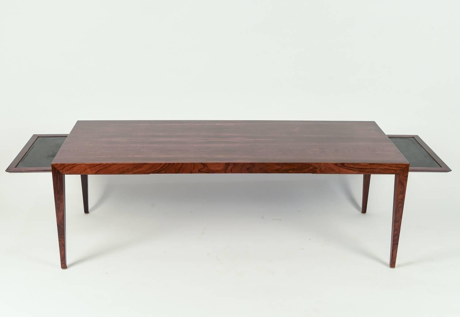 This Danish midcentury coffee table designed by Severin Hansen for Haslev features two pullout extensions on either side. A great daily piece that can be altered to accommodate guests. Crafted of handsome rosewood and is a great example of Severin