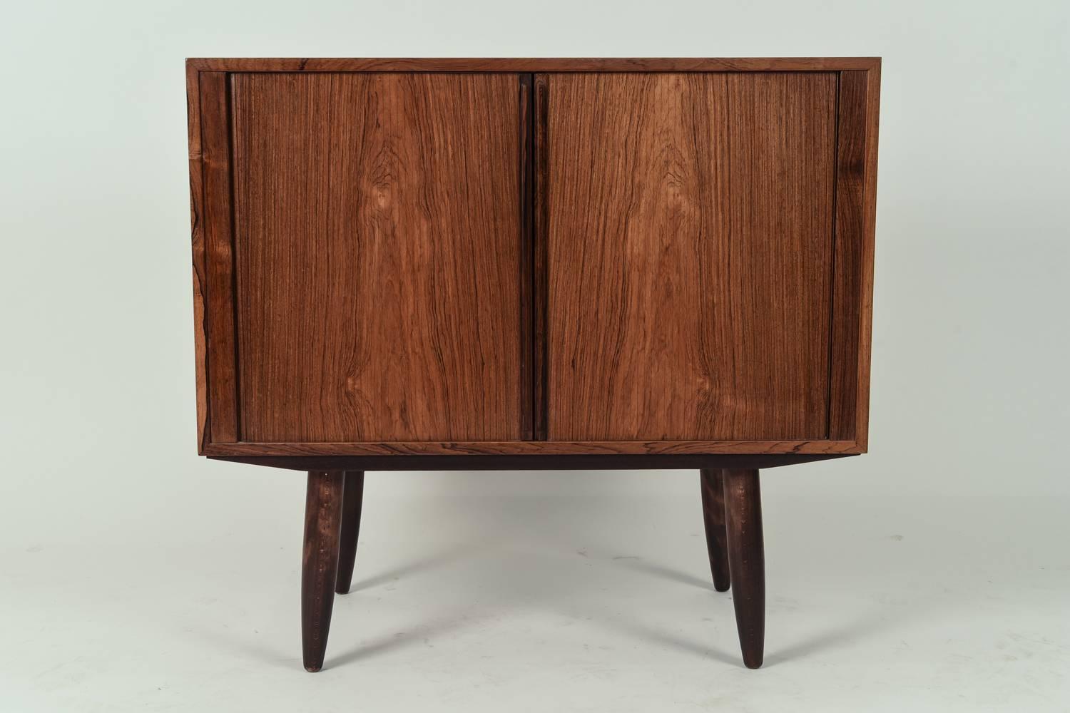 A great Mid-Century rosewood cabinet with tambour doors. Designed by Kai Kristiansen for Feldballes Møbelfabrik.
