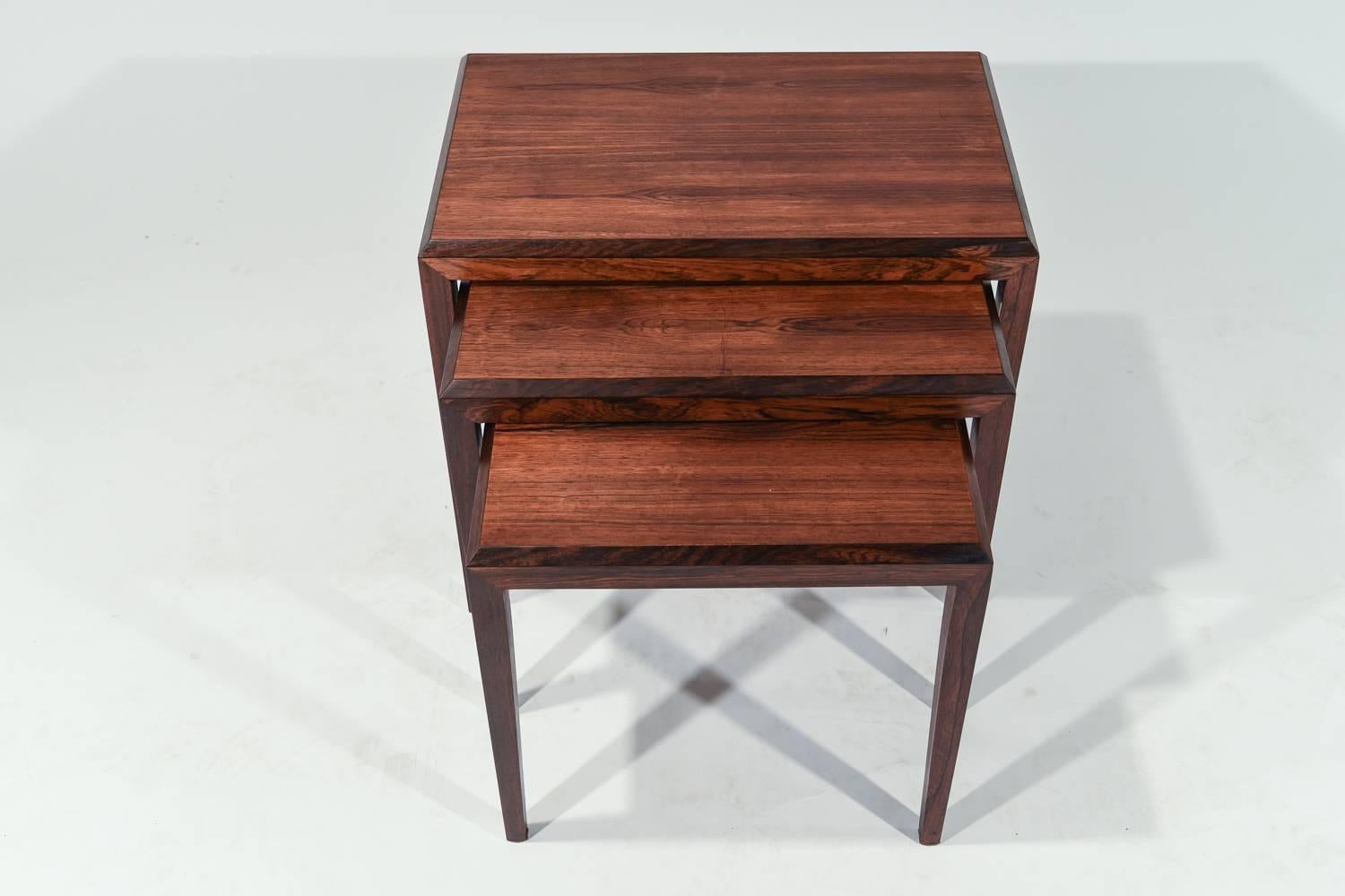 This set of three nesting tables was designed by Johannes Andersen for Silkeborg, circa 1965. Crafted of handsome rosewood with stunning color and grain.